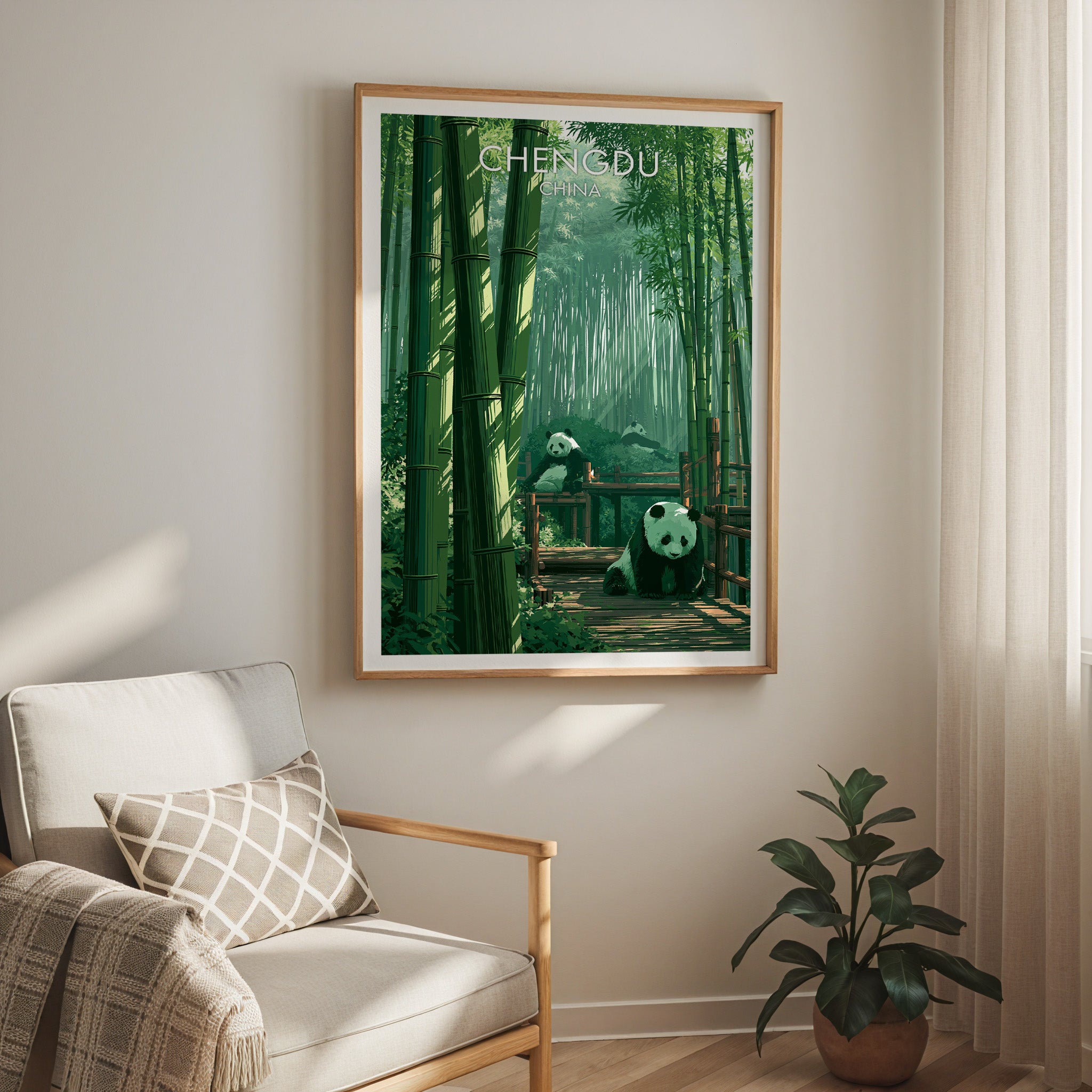 Giant Pandas Chengdu China travel print in a light oak frame on a living room wall beside a linen armchair