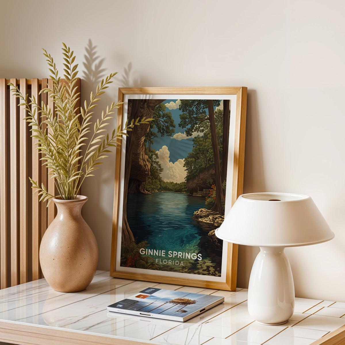 Spring river wall art on a balanced stone table with a dried-leaf vase, white dome lamp and magazines