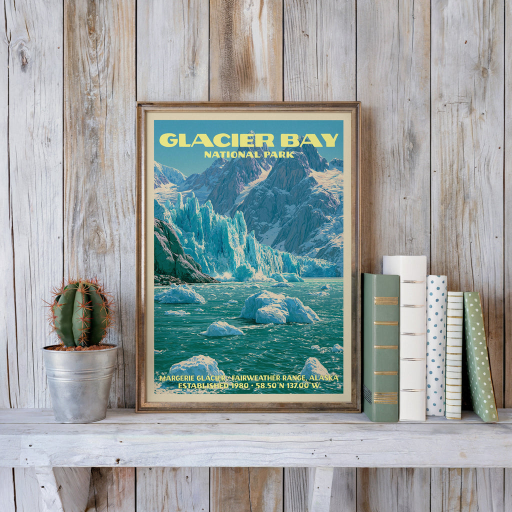 Glacier Bay vintage poster in a slim gold frame on a whitewashed plank wall beside a tin cactus and books