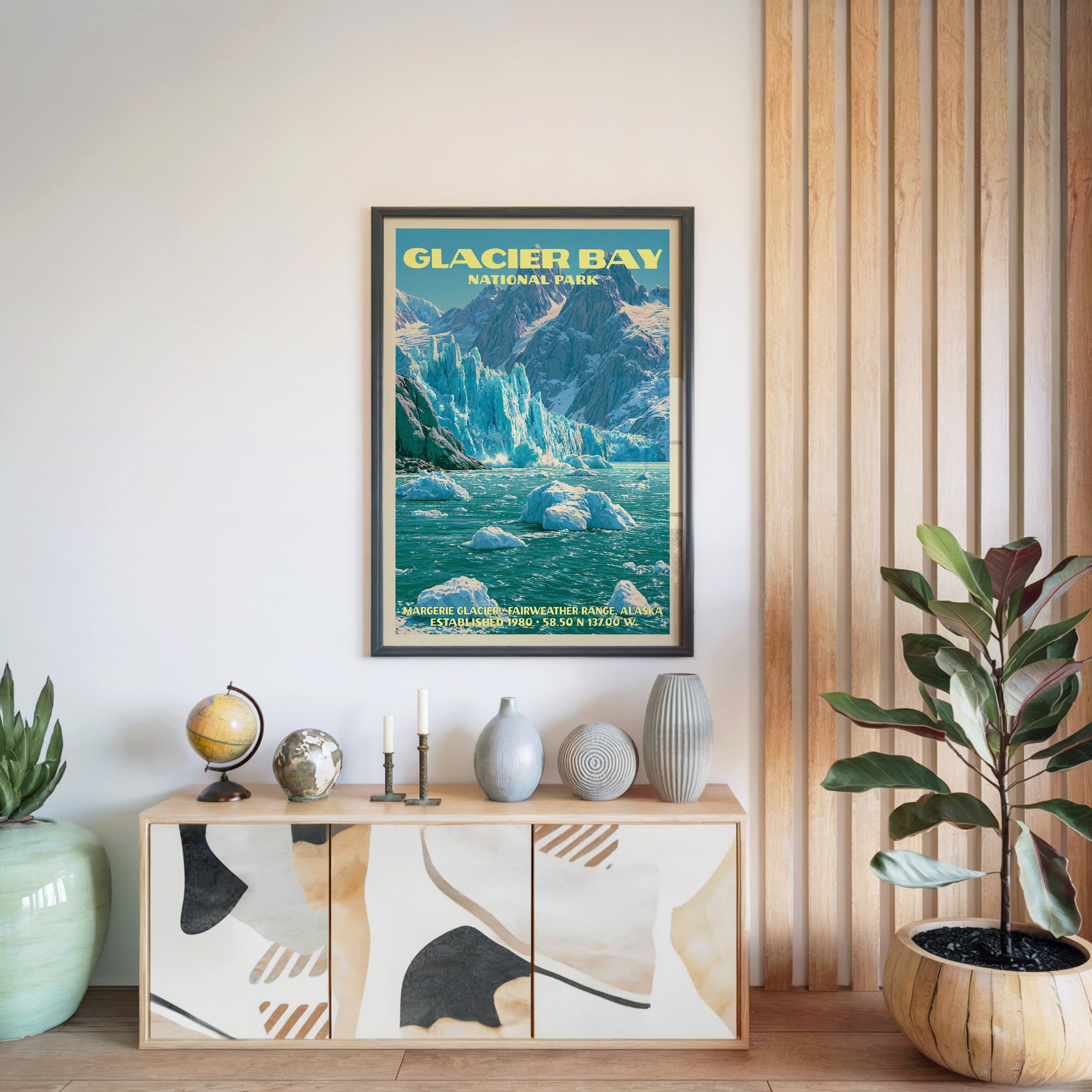 Glacier Bay National Park poster in a black frame above a light wood sideboard beside a slatted wall panel