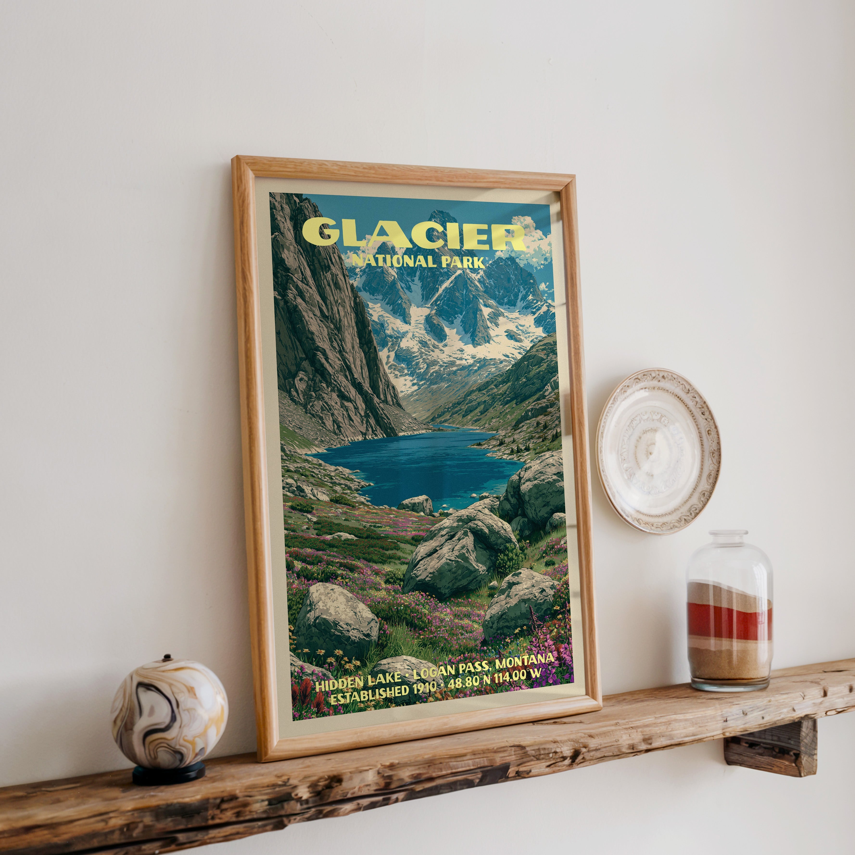 Glacier National Park Hidden Lake print in oak, leaning on a wood ledge with a stone sphere and sand jar
