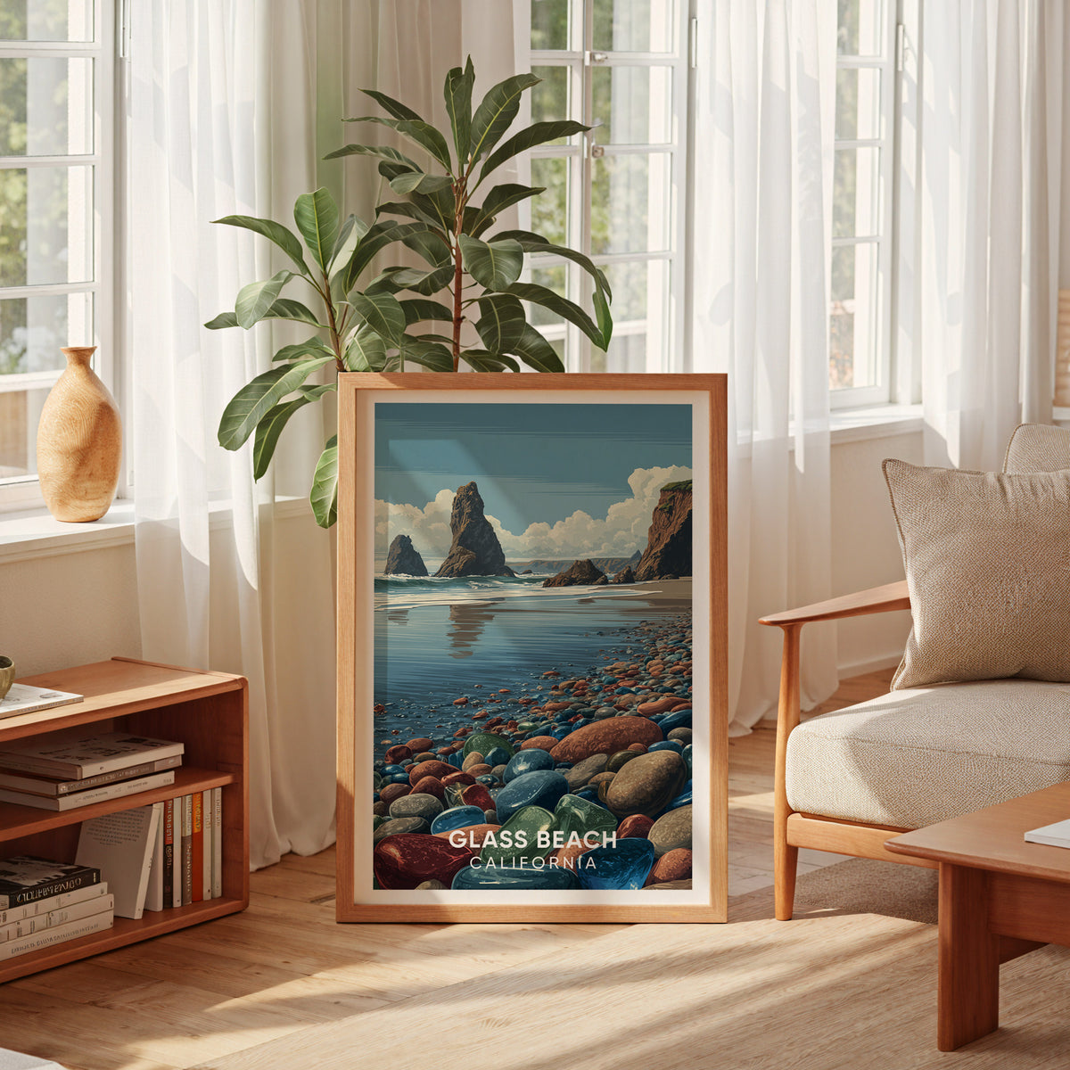 Sea glass pebble print leaning by a curtained window with a tall plant, low bookshelf and cream armchair