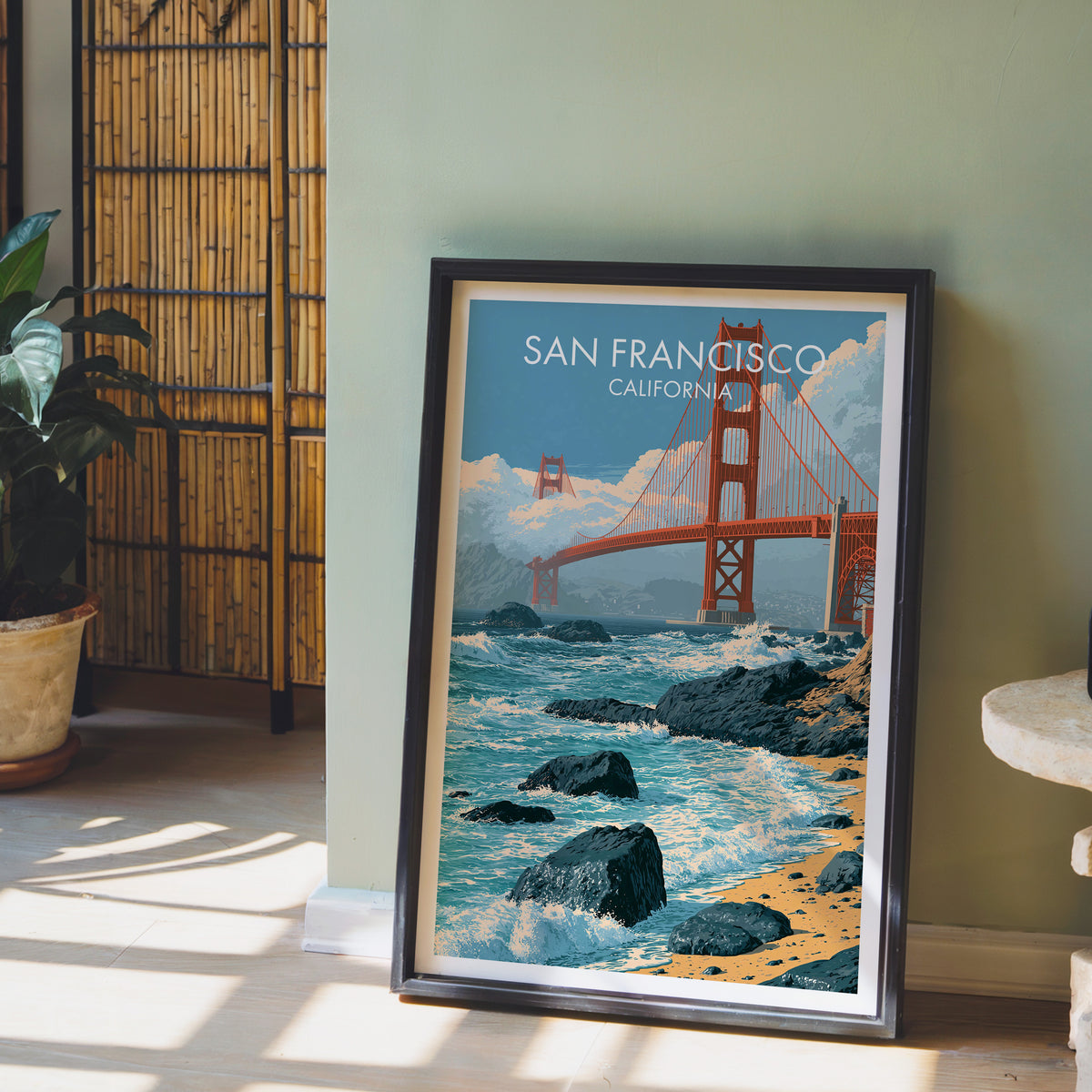 San Francisco bridge print in a black frame on a sage wall with a bamboo screen and potted orchid.