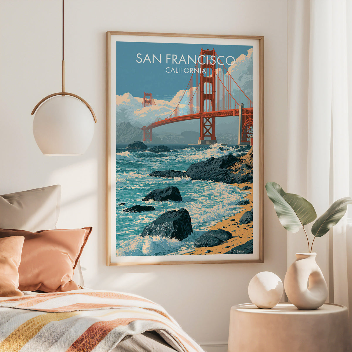 Large Golden Gate Bridge poster in an oak frame above a bed with a rust throw and pendant lamp.