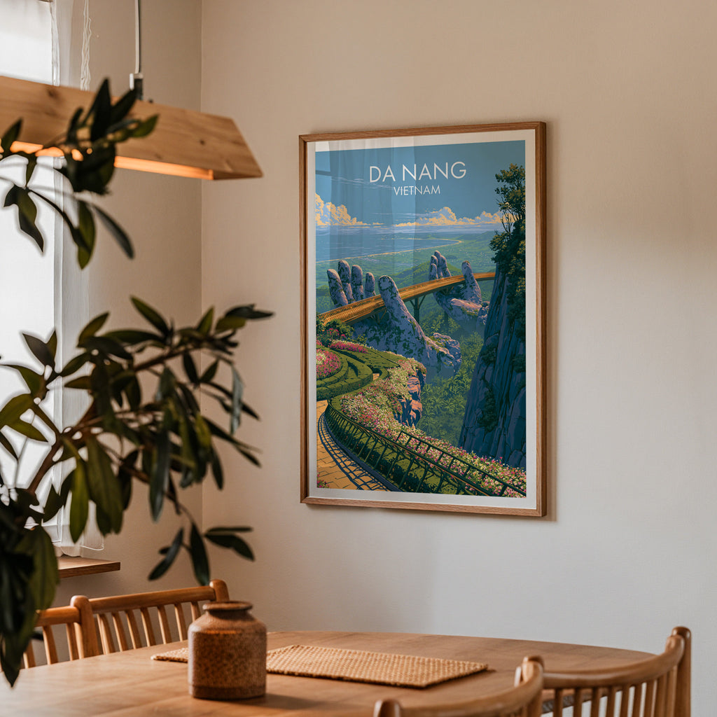 Framed Golden Bridge Da Nang Vietnam print on a dining room wall above an oak table in warm afternoon light