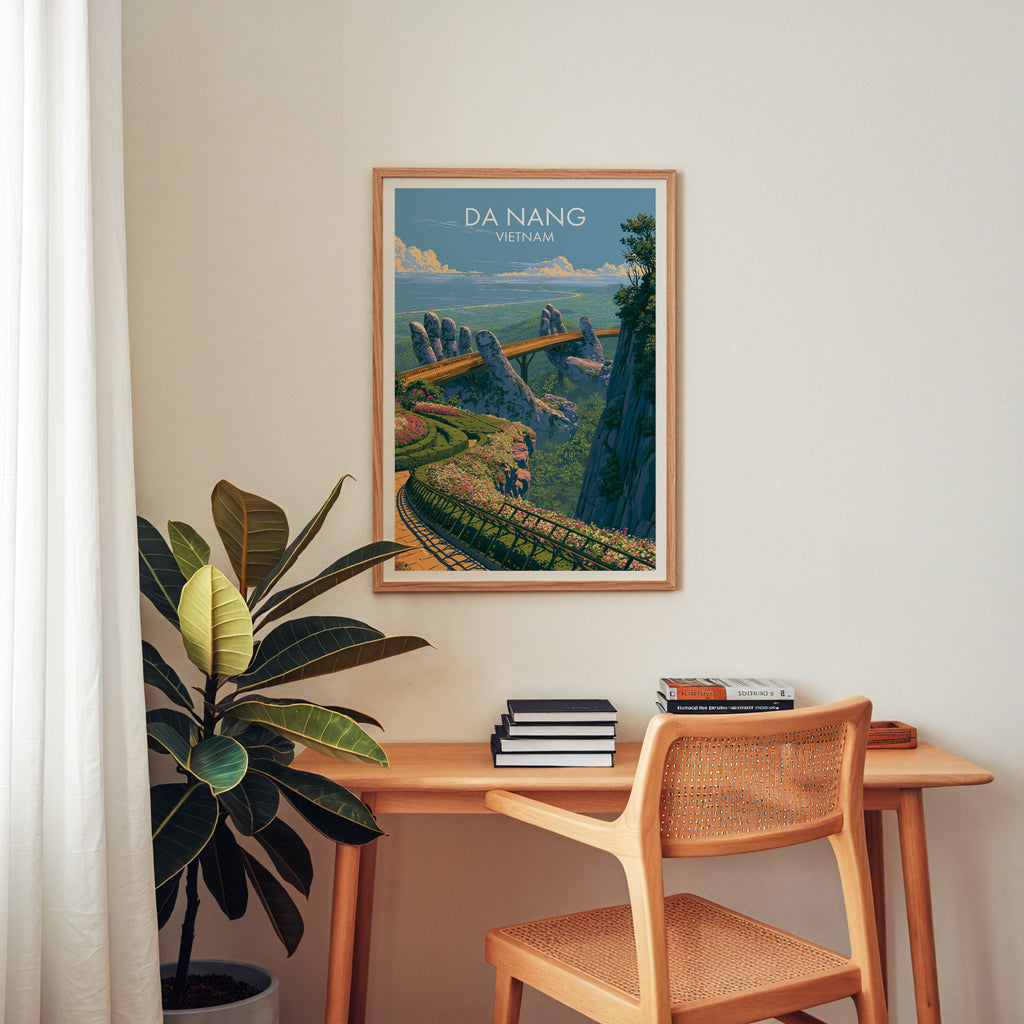 Golden Bridge Da Nang Vietnam wall art above a wooden home office desk with a rattan chair and books