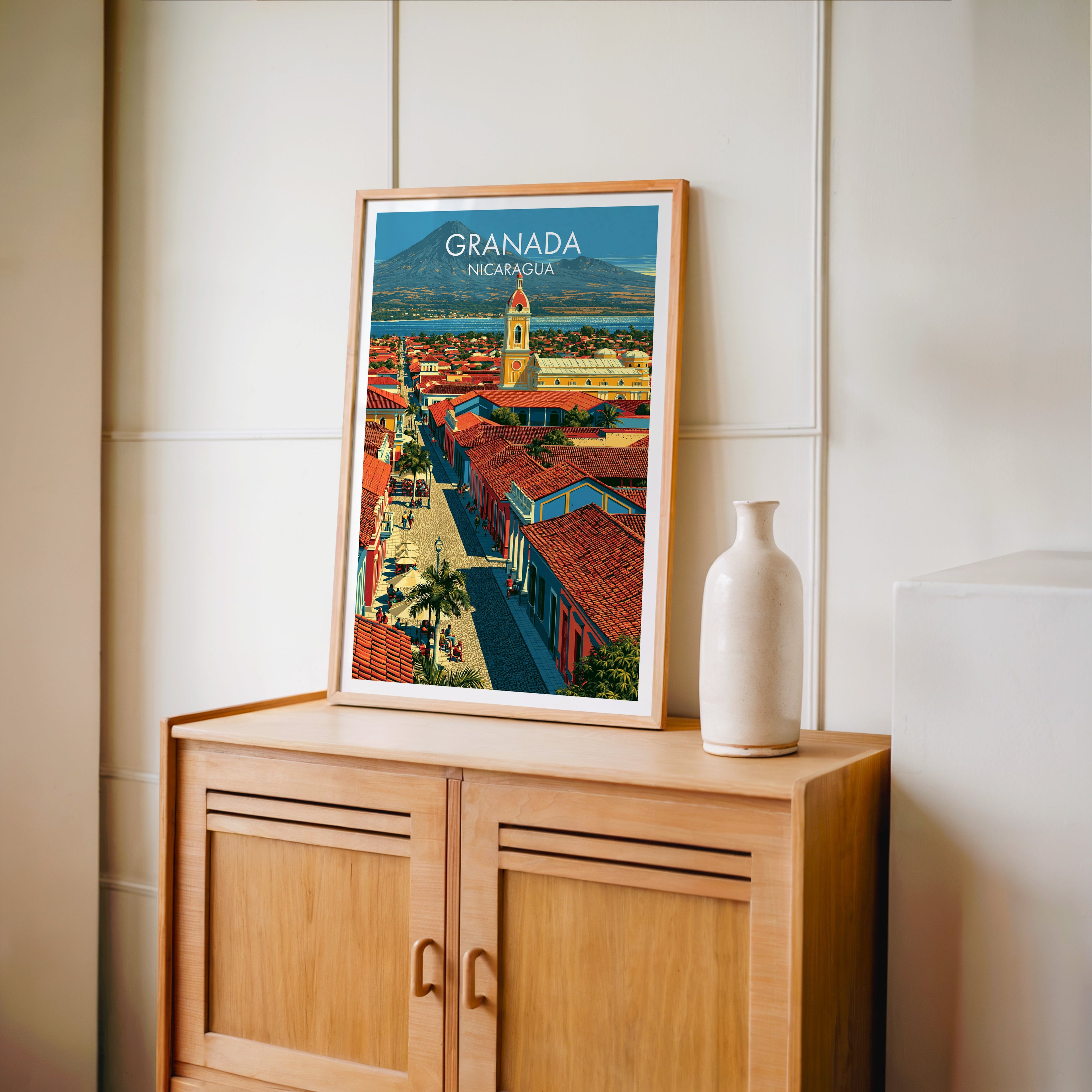 White parasols along the paved street, oak frame on a light oak cabinet by a cream panelled wall and vase