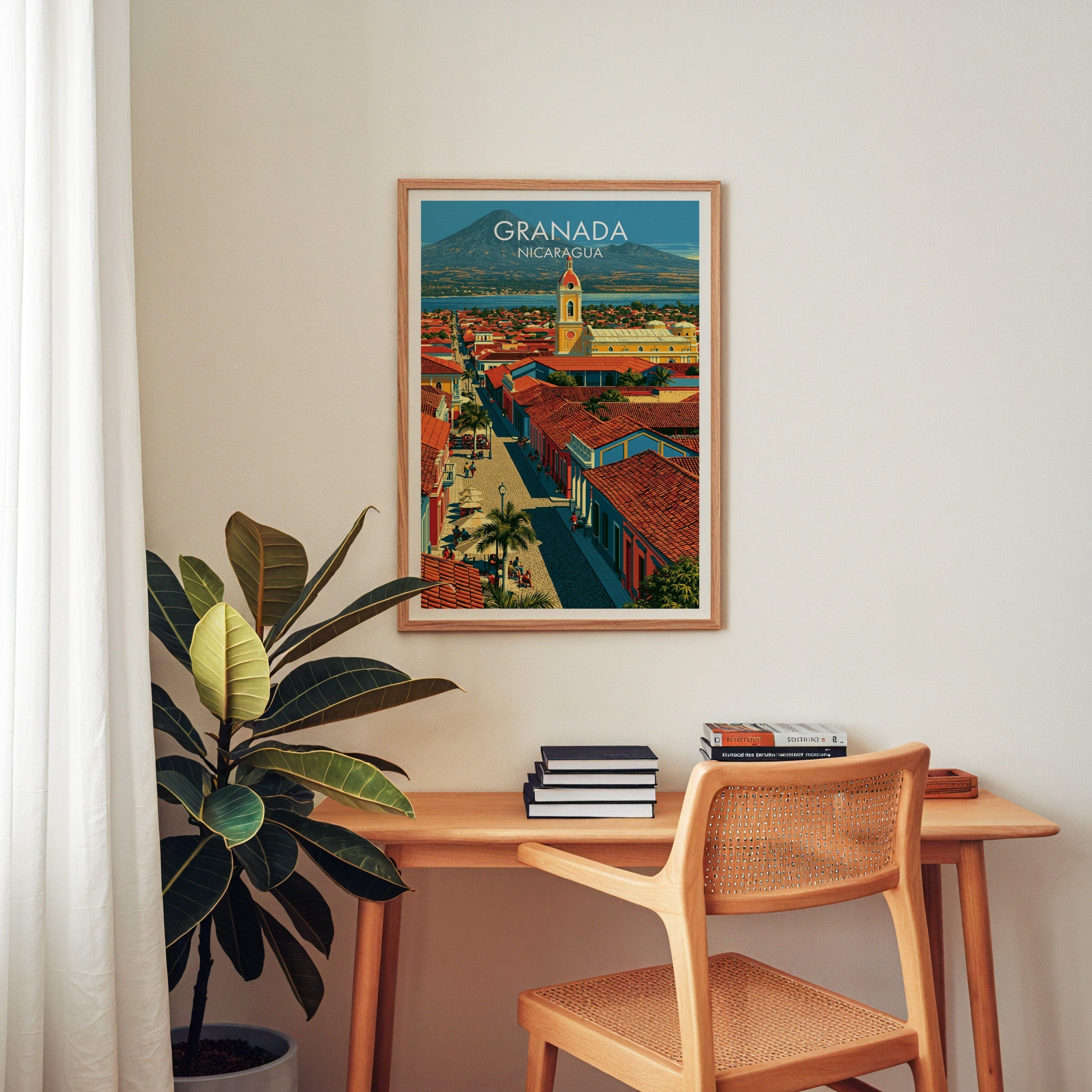 Central America travel print in an oak frame above a home-office desk with a cane chair and rubber plant
