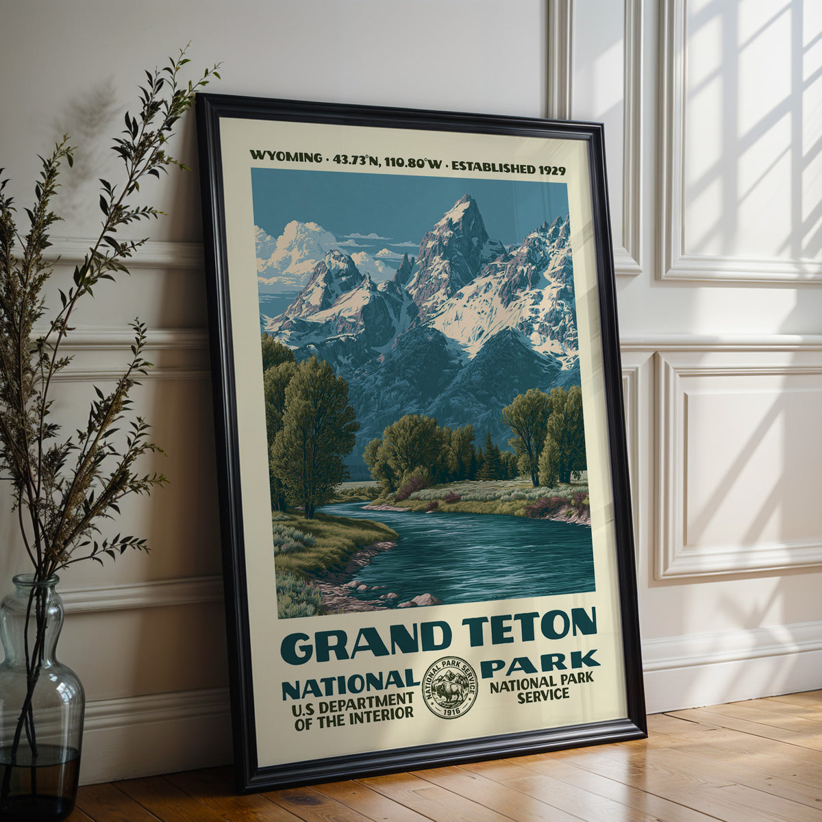 Large Grand Teton National Park WPA poster in a black frame leaning on a white panelled wall