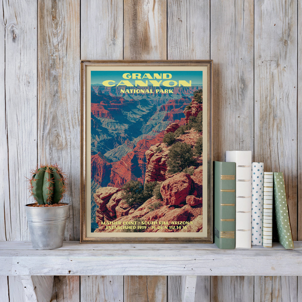 Grand Canyon vintage poster in a slim gold frame on a whitewashed plank wall beside a cactus and books