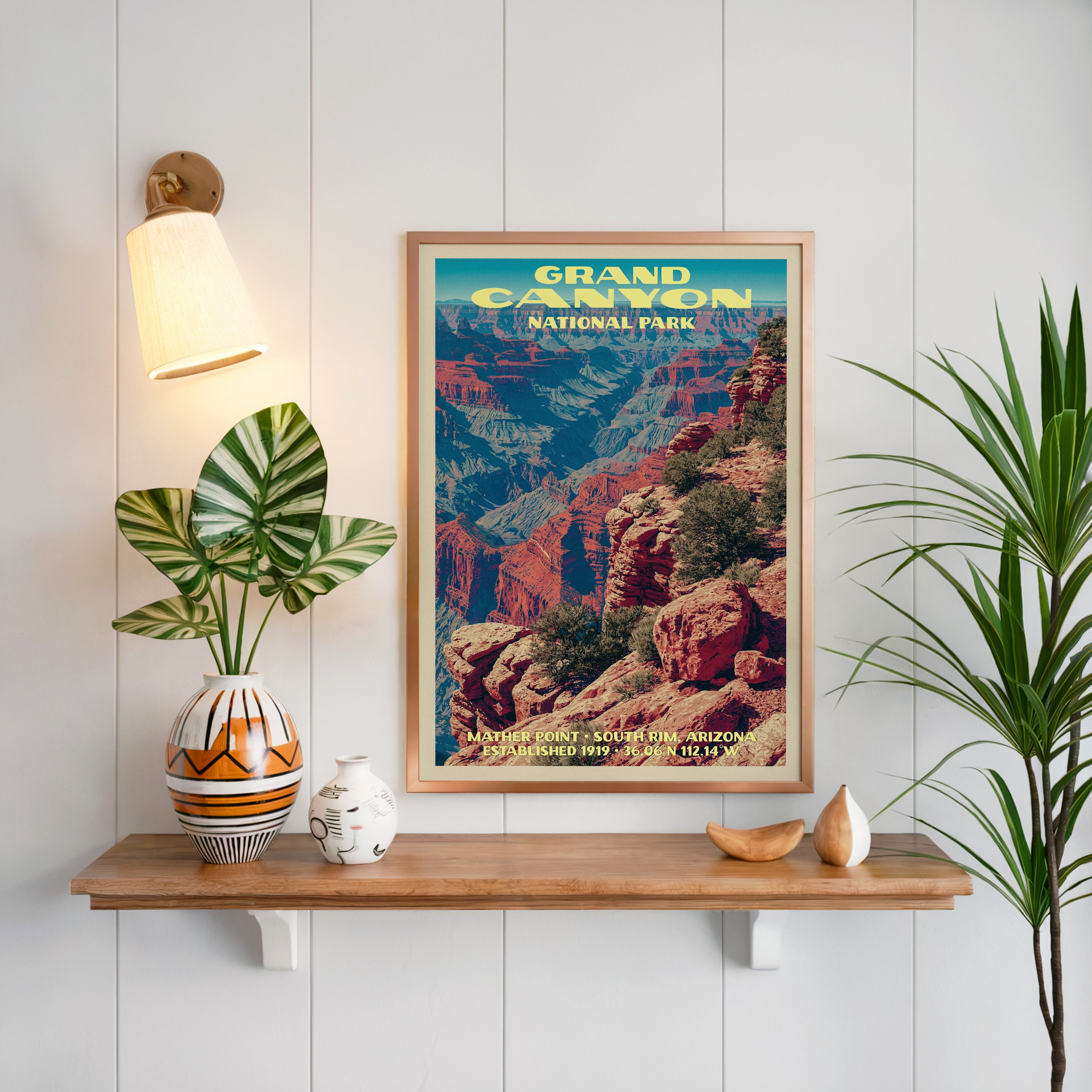 Mather Point print framed on white panelling above an oak shelf with a patterned vase and a brass sconce