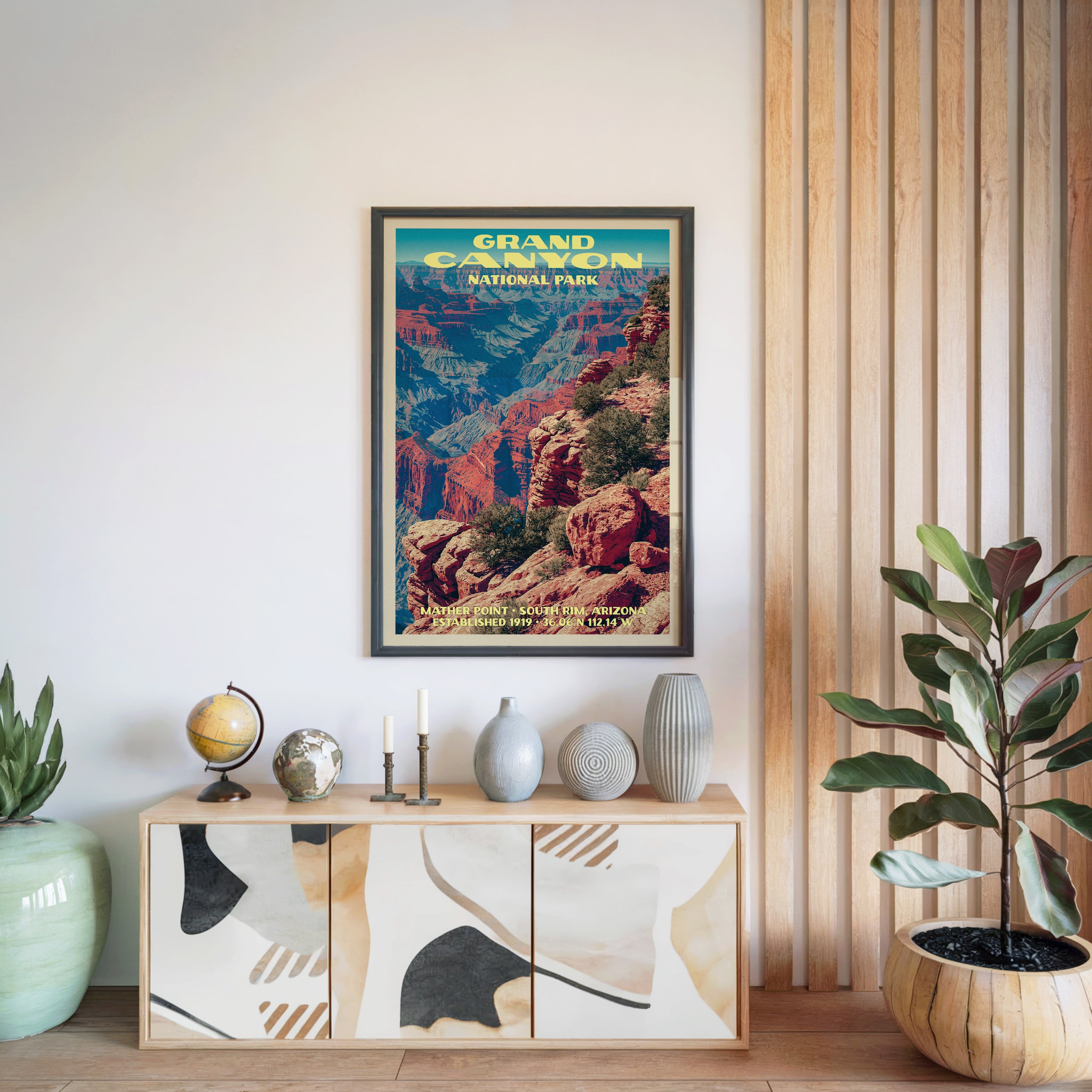 Grand Canyon National Park poster in a black frame above a light wood sideboard beside a slatted panel