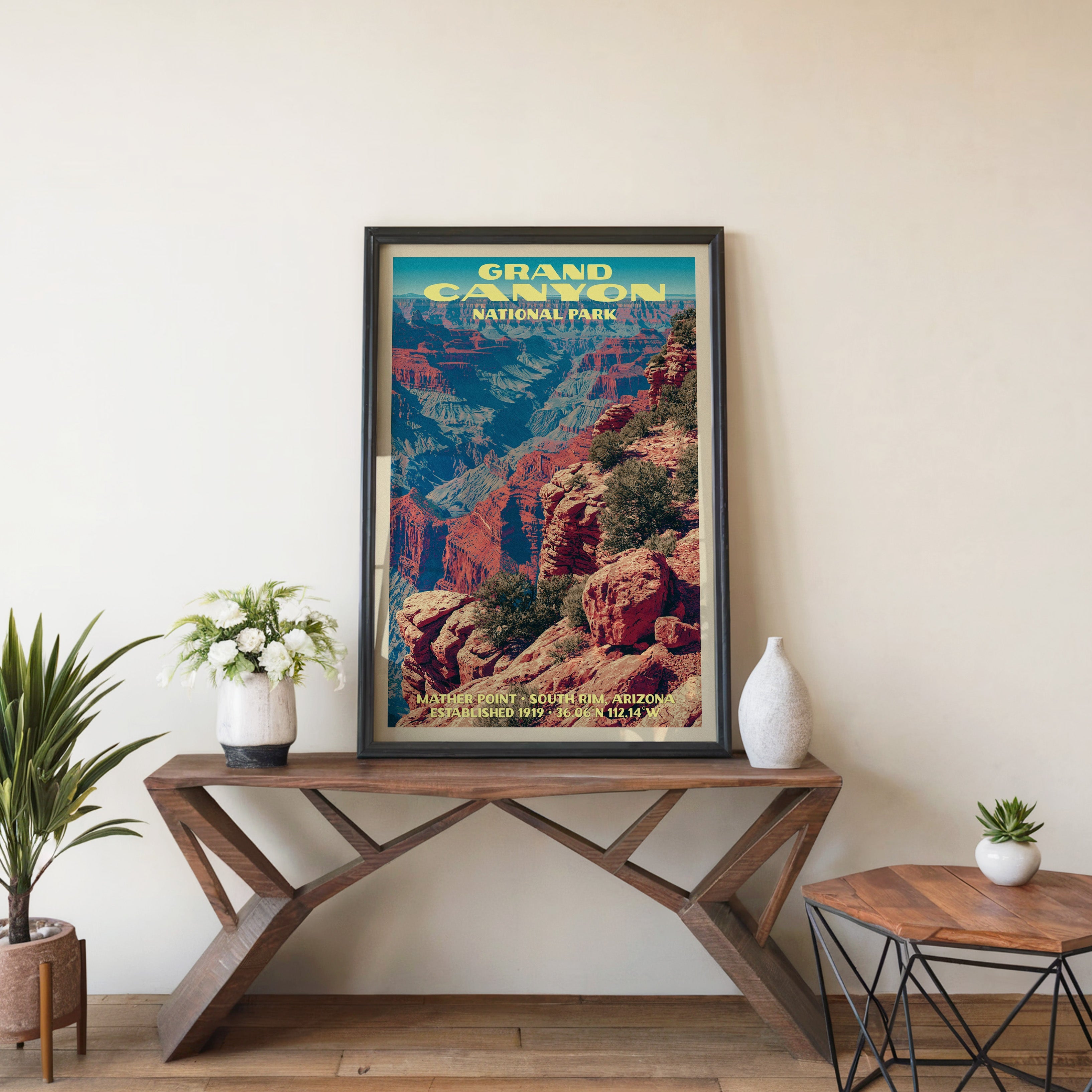 Grand Canyon Mather Point wall art in black, leaning on a walnut console with white anemones in a vase