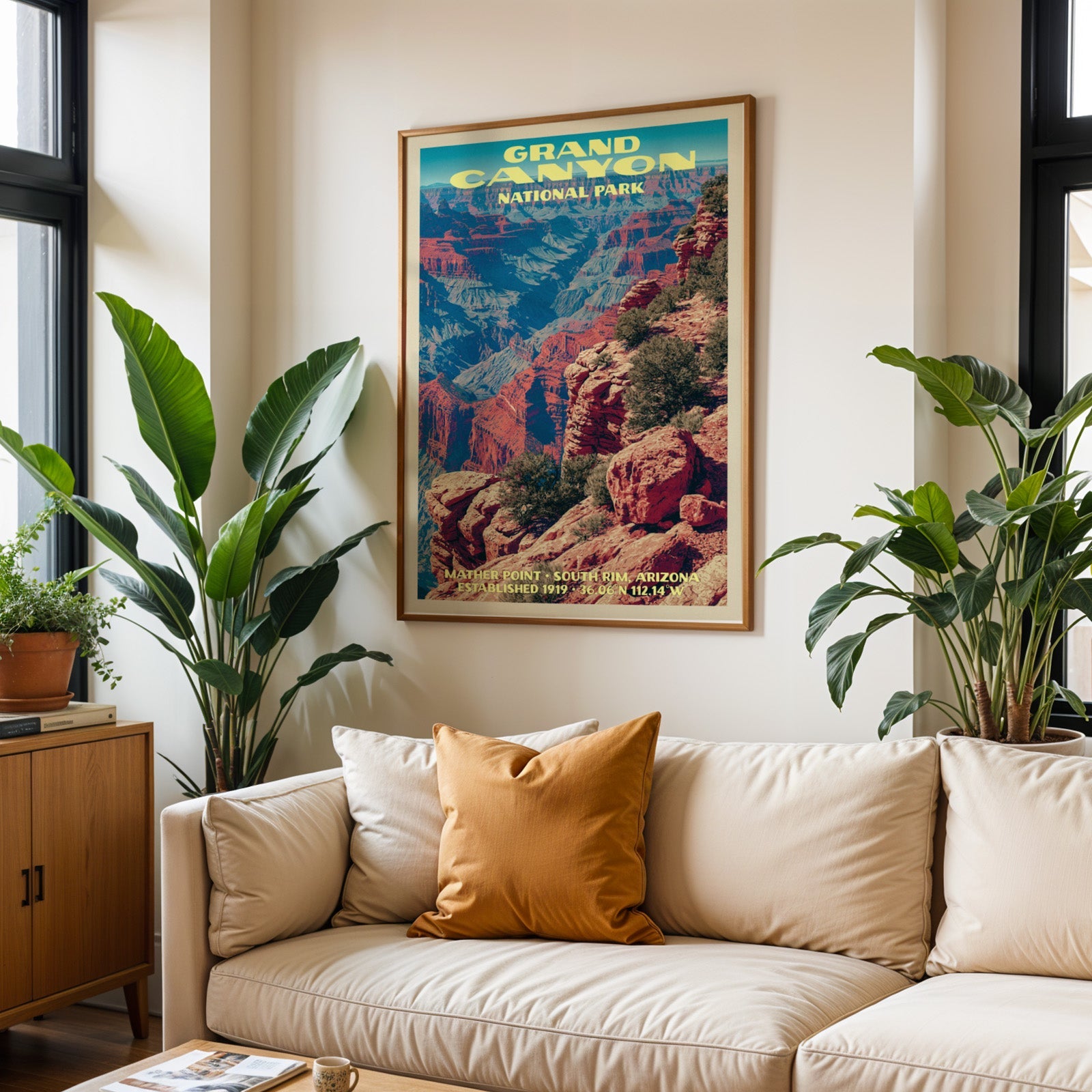 Grand Canyon vintage travel print in oak above a cream sofa with a rust cushion and tall houseplants
