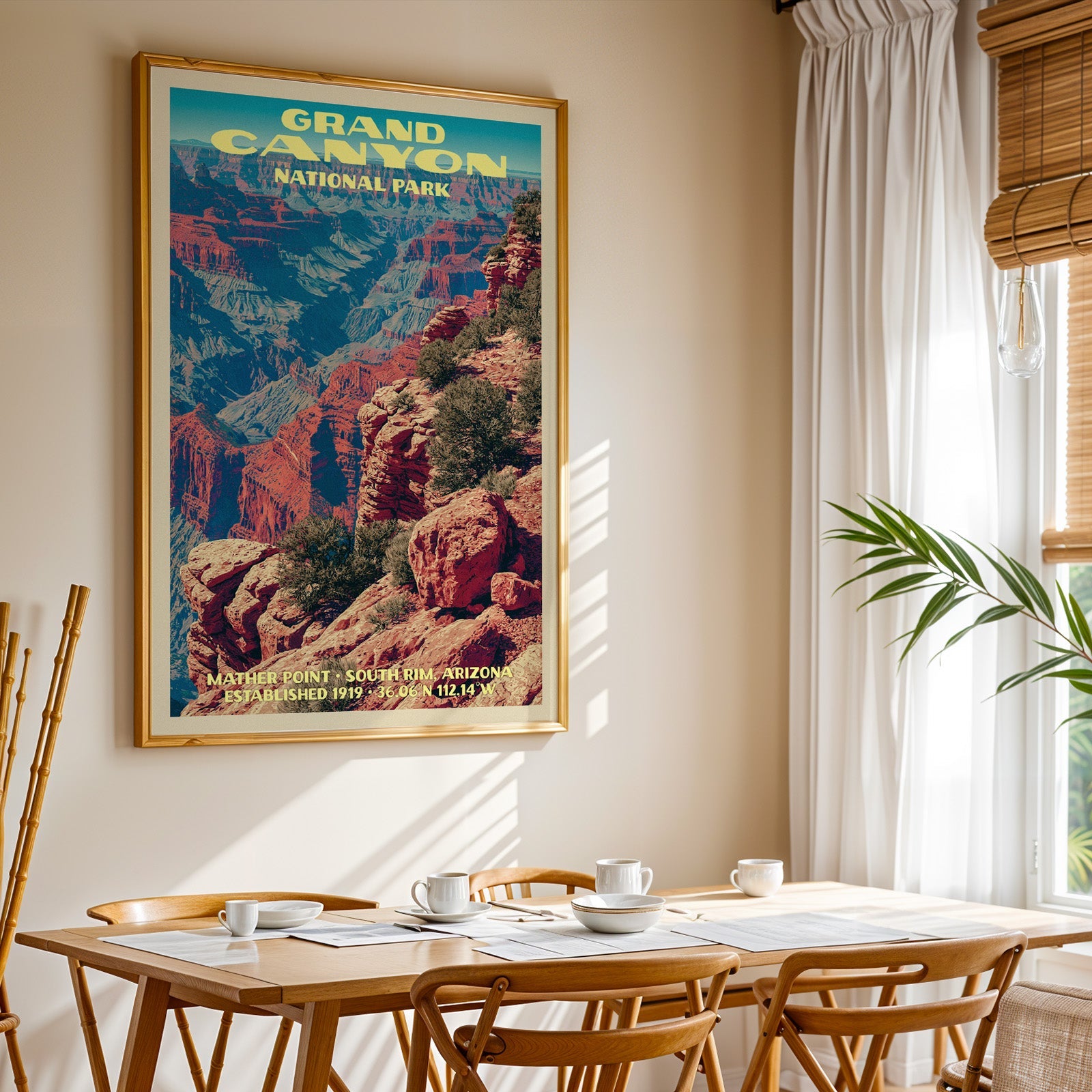 Grand Canyon National Park print in gold above a light oak dining table by a sheer-curtained window