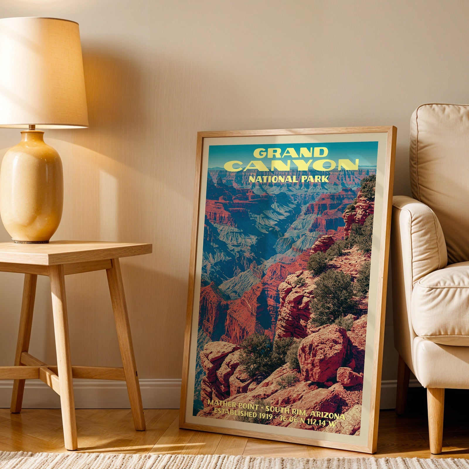 Mather Point Grand Canyon wall art in oak, leaning by an armchair and a side table with an ochre lamp