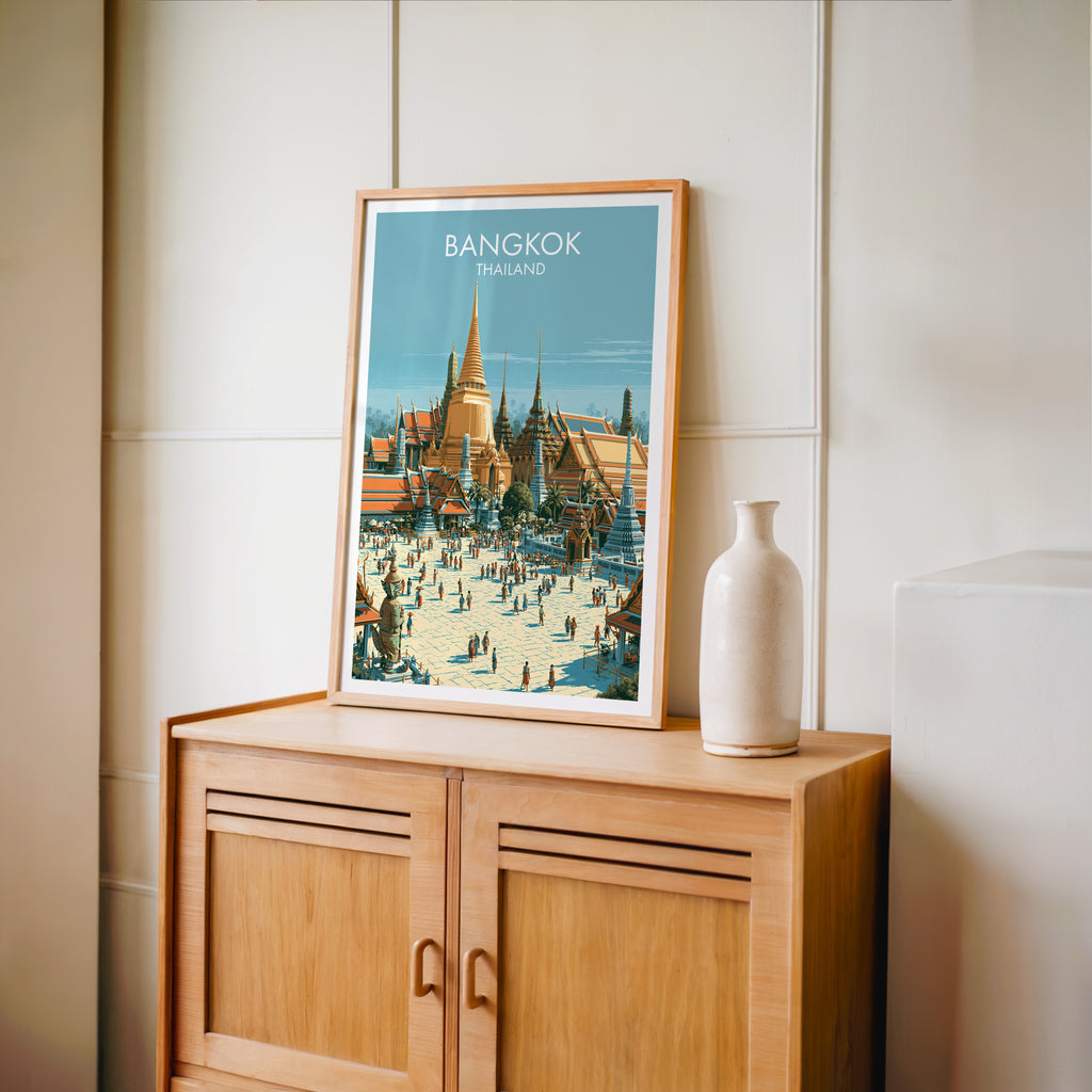 Small Grand Palace Bangkok Thailand travel poster in an oak frame on a mid-century sideboard with a ceramic vase