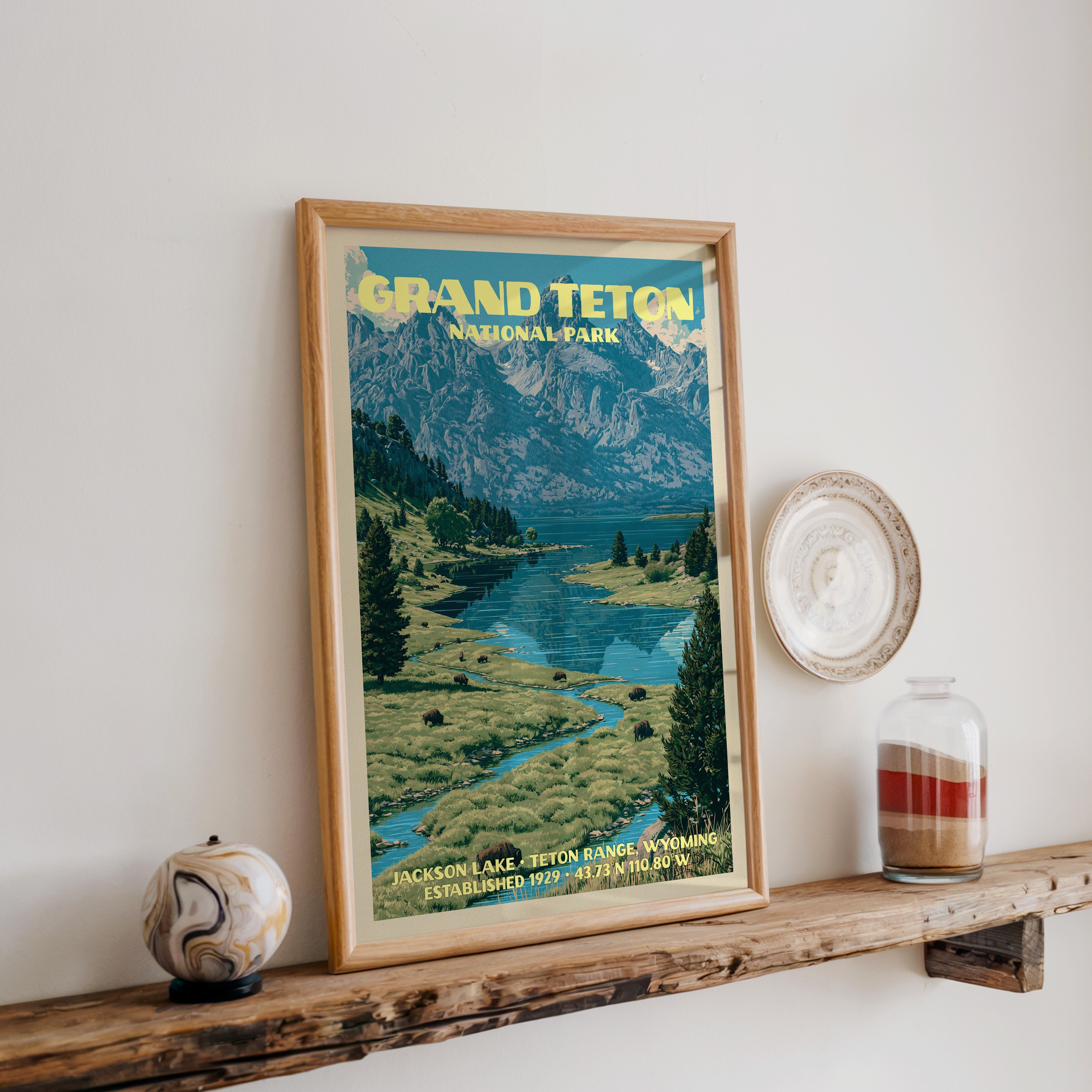 Grand Teton Jackson Lake print in oak, leaning on a reclaimed wood ledge with a stone sphere and sand jar