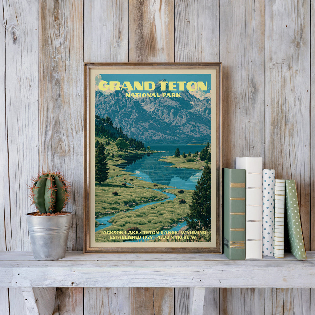 Grand Teton vintage poster in a slim gold frame on a whitewashed plank wall beside a cactus and pastel books