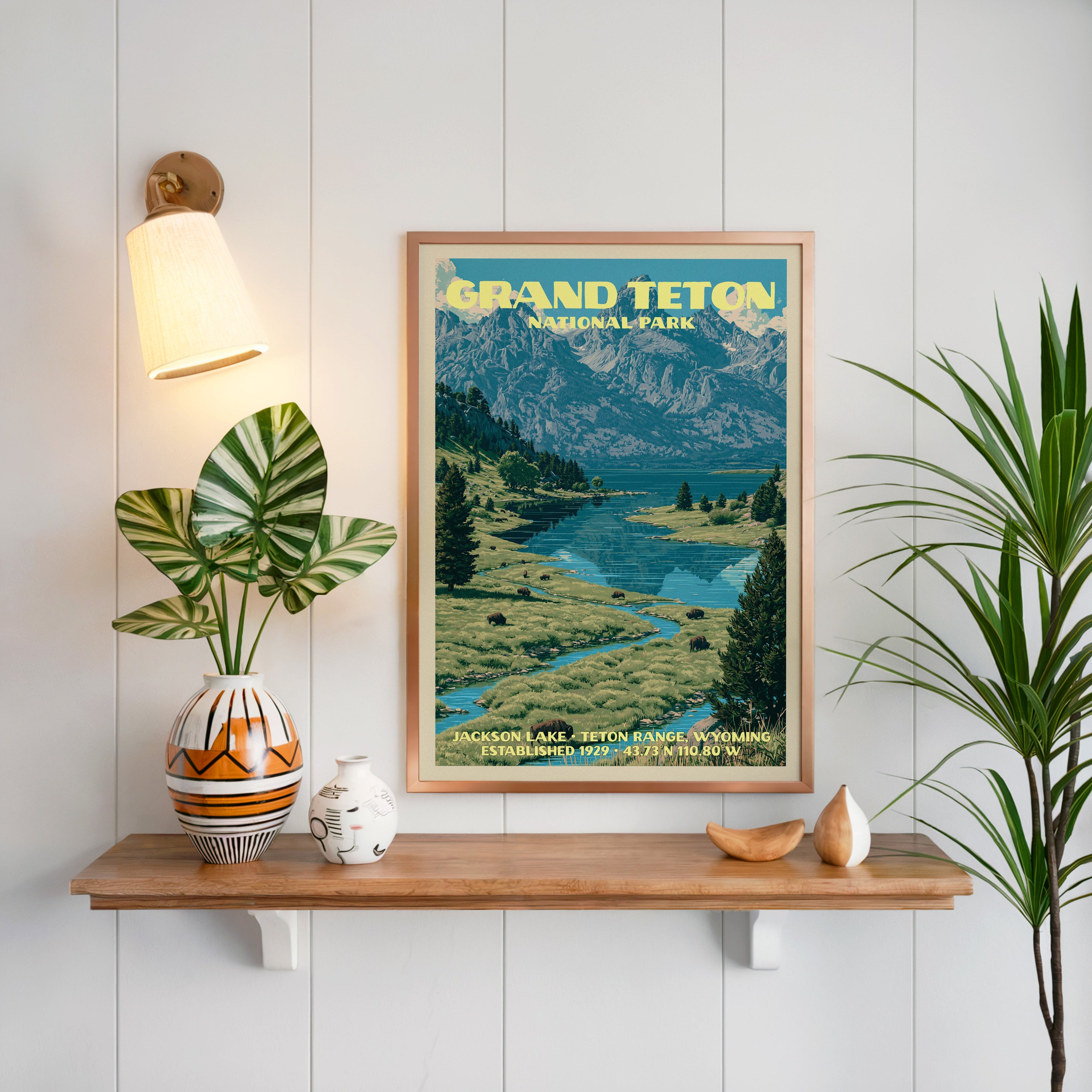 Jackson Lake print framed on white panelling above an oak shelf with a patterned vase and a brass sconce