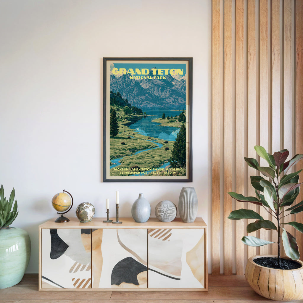 Grand Teton National Park poster in a black frame above a light wood sideboard beside a slatted wall panel
