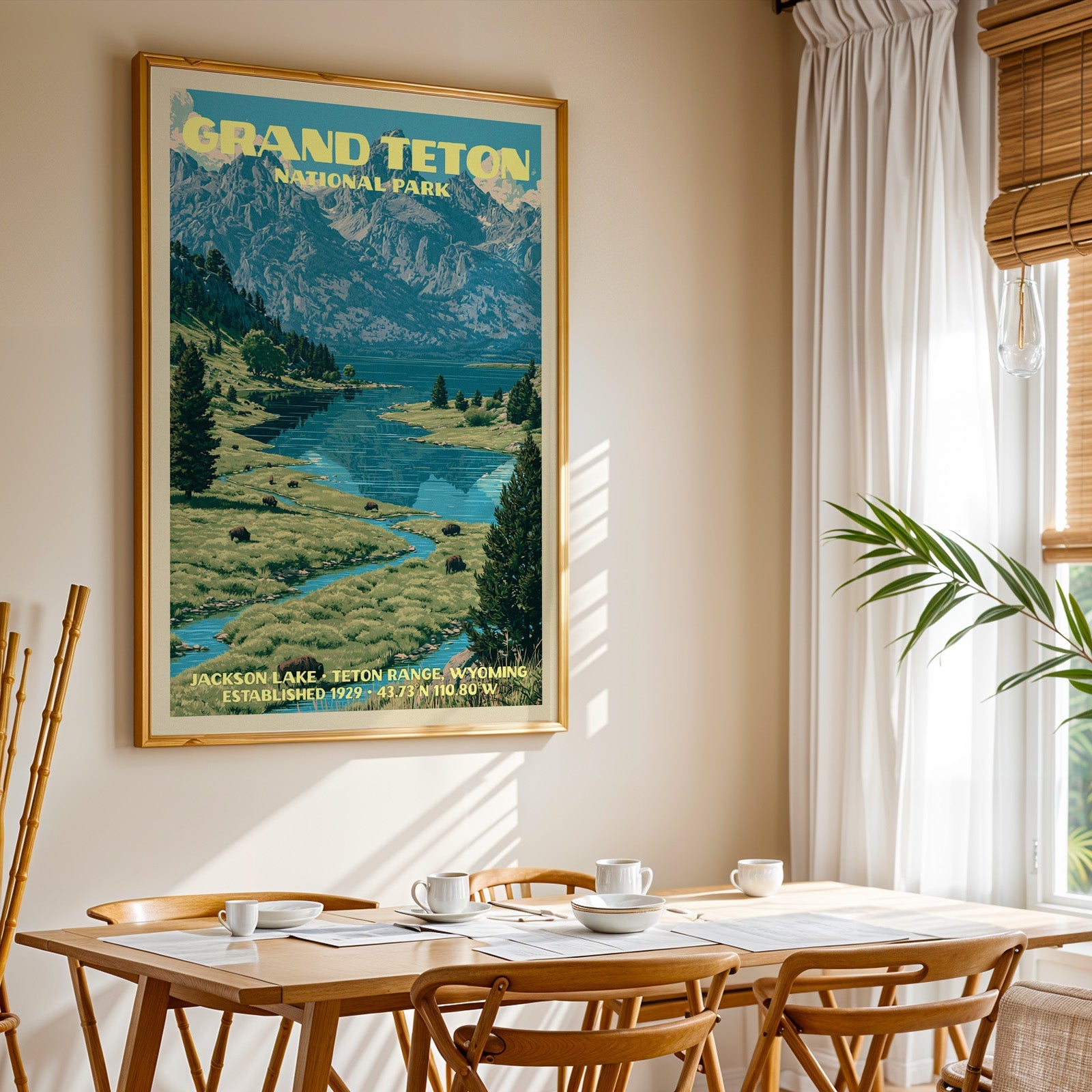 Grand Teton National Park print in gold above a light oak dining table by a sheer-curtained window