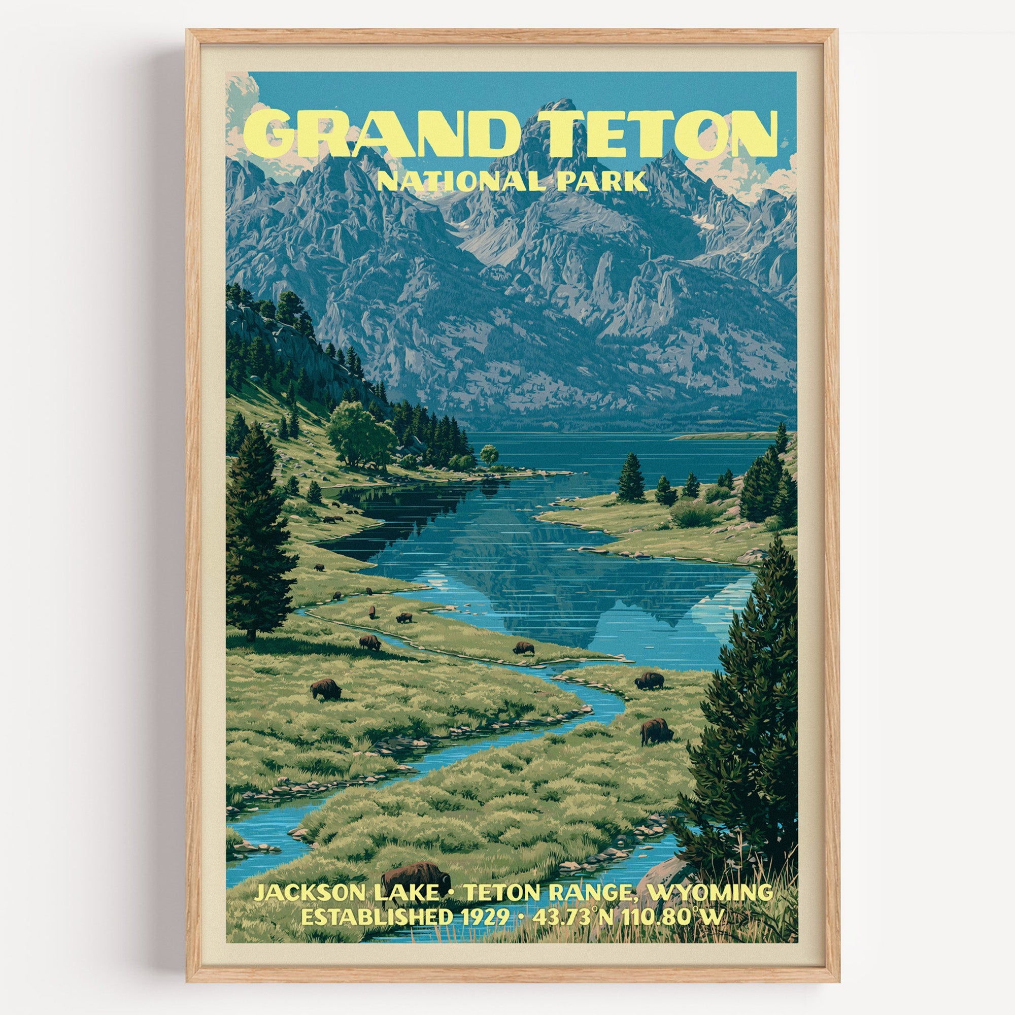 Jackson Lake Grand Teton vintage poster in a light oak frame on a plain white wall