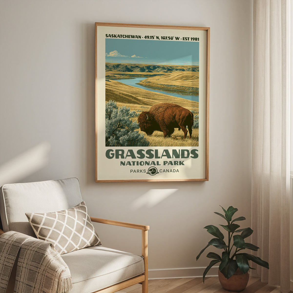 Grasslands National Park print in an oak frame above a cream armchair and a rubber plant