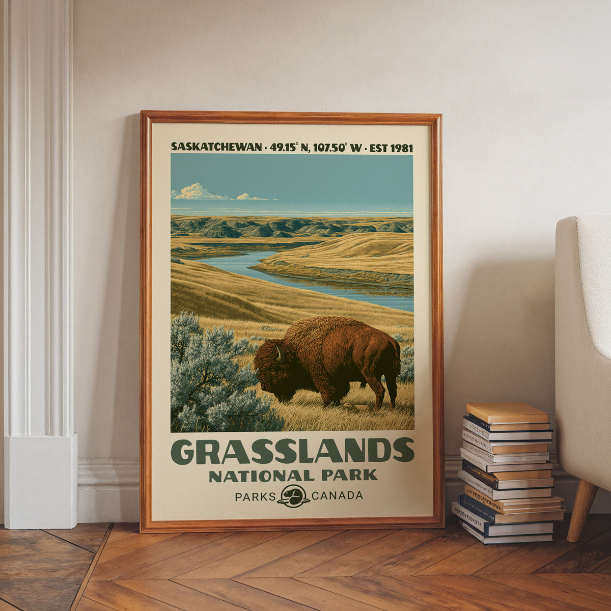 Saskatchewan badlands valley wall art in a walnut frame on a herringbone floor beside stacked books