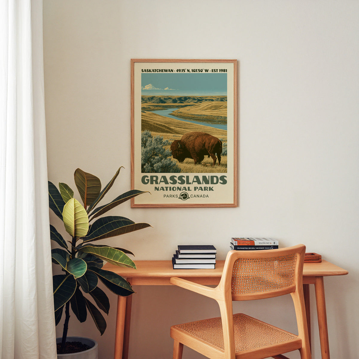 Grasslands Canada vintage poster in an oak frame above a wood desk with a cane chair