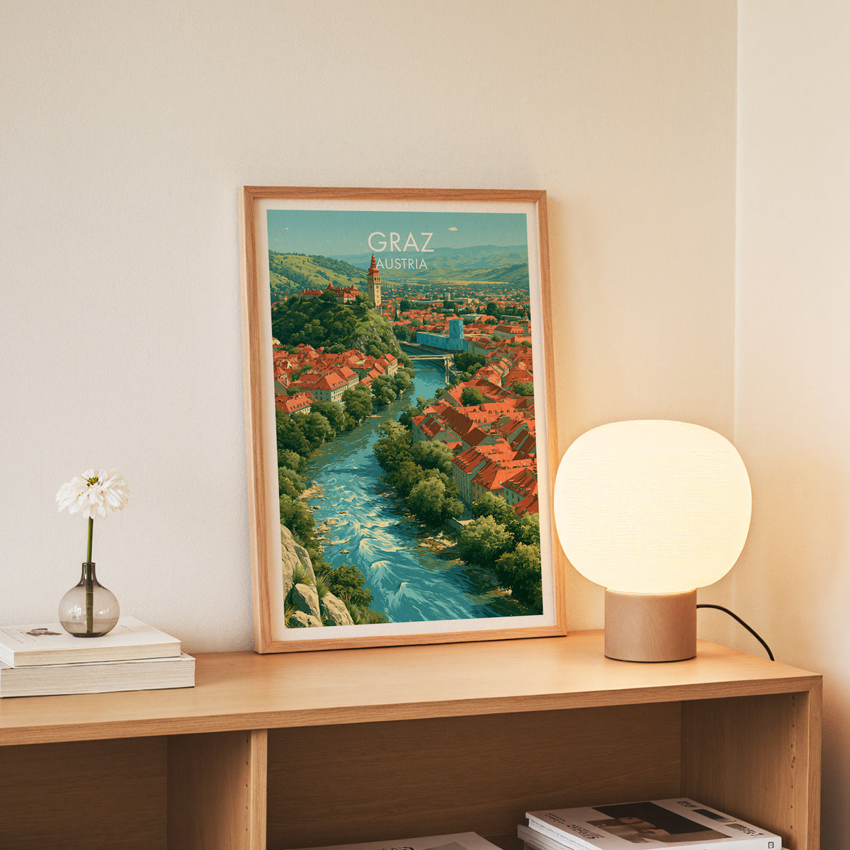 Graz Austria wall art, slim oak frame standing on an oak console beside a daisy in a glass bottle