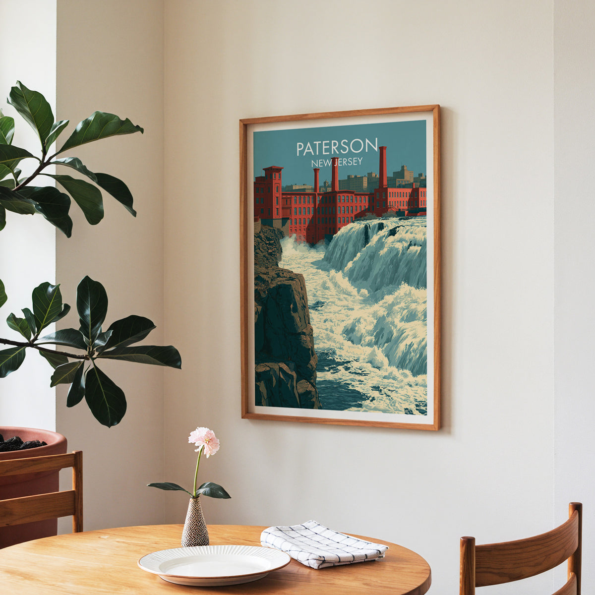 Waterfall and mills wall art in a walnut frame in a dining nook with roses and a fiddle-leaf fig