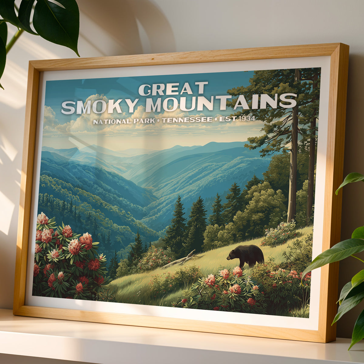Great Smoky Mountains National Park wall art print in a light oak frame, leaning on a white shelf in warm sunlight beside a monstera plant