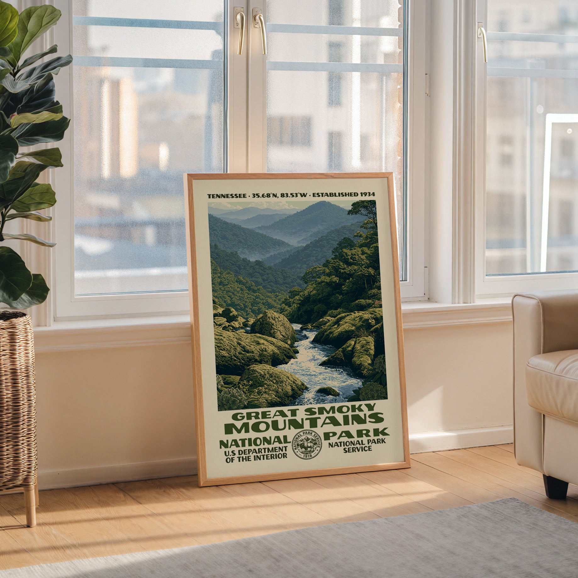 Great Smoky Mountains National Park WPA wall art in a wood frame by a tall window with a city skyline view