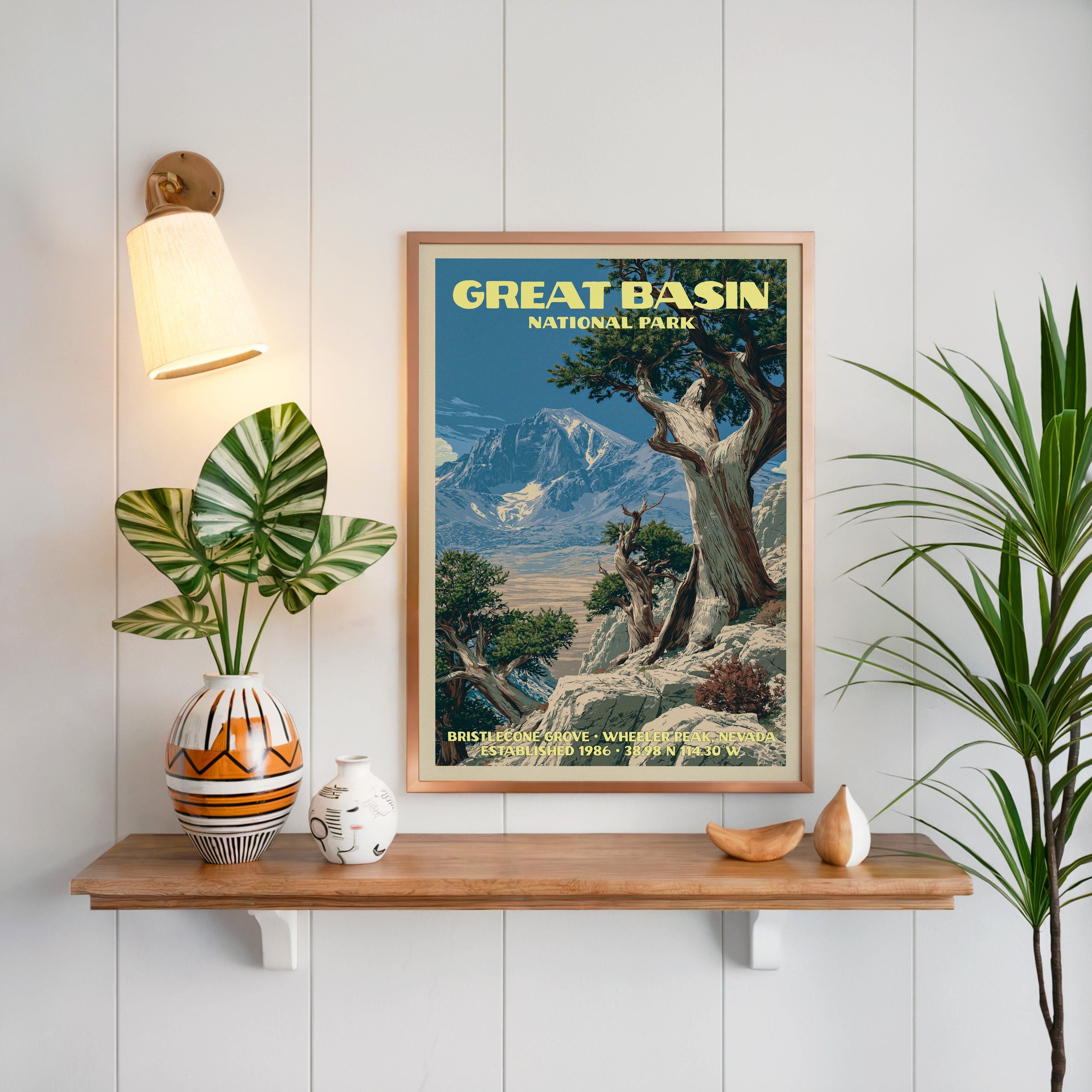 Bristlecone Grove print framed on white panelling above a floating oak shelf with a patterned vase and brass sconce