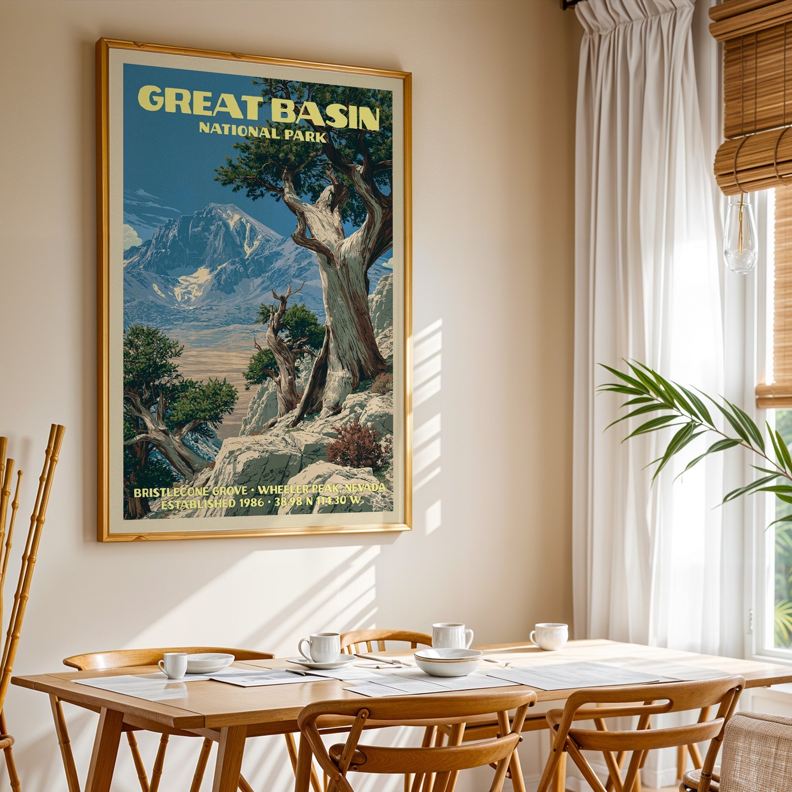 Great Basin National Park print in a gold frame above a light oak dining table by a curtained window