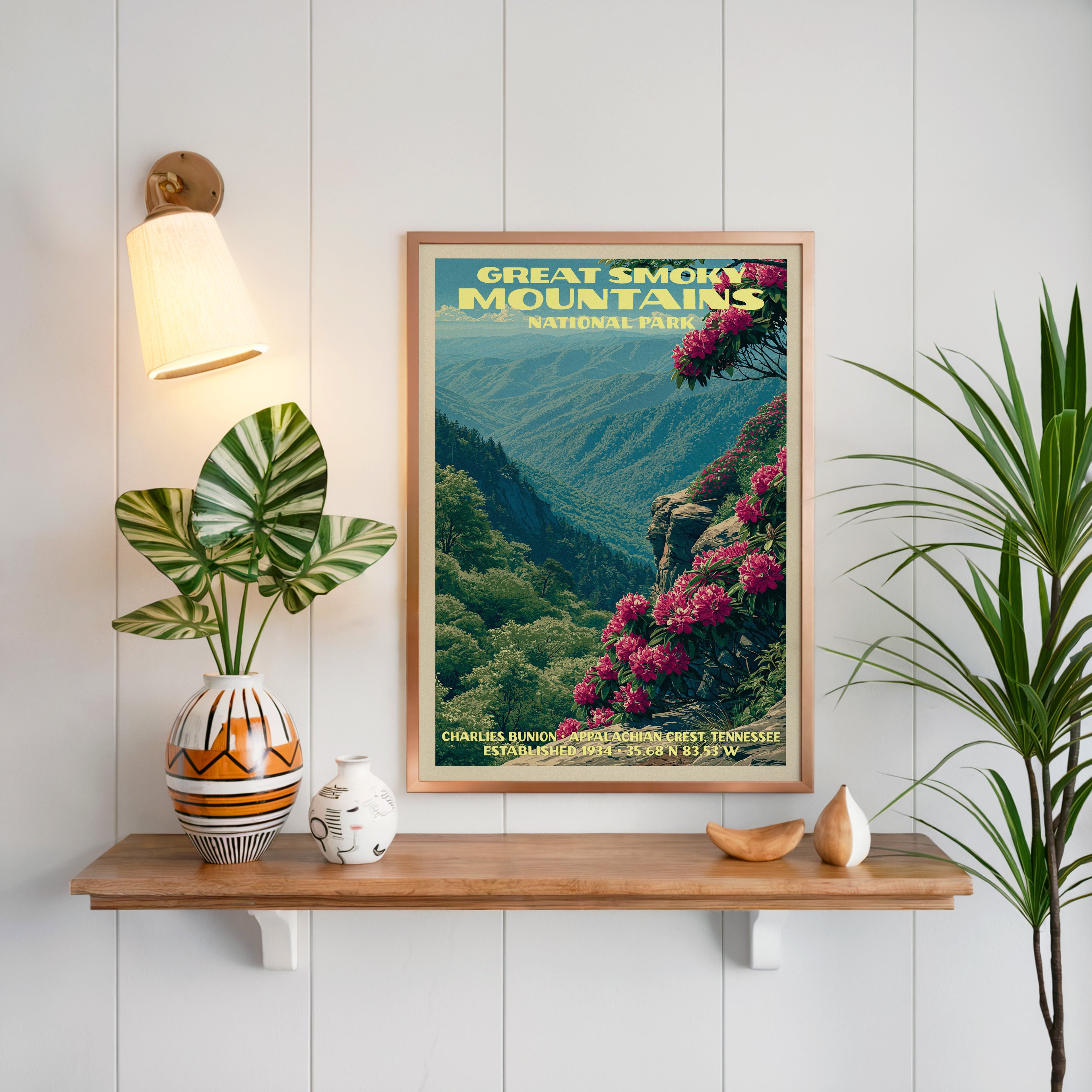 Great Smoky Mountains print framed on white panelling above a floating oak shelf with a patterned vase and sconce