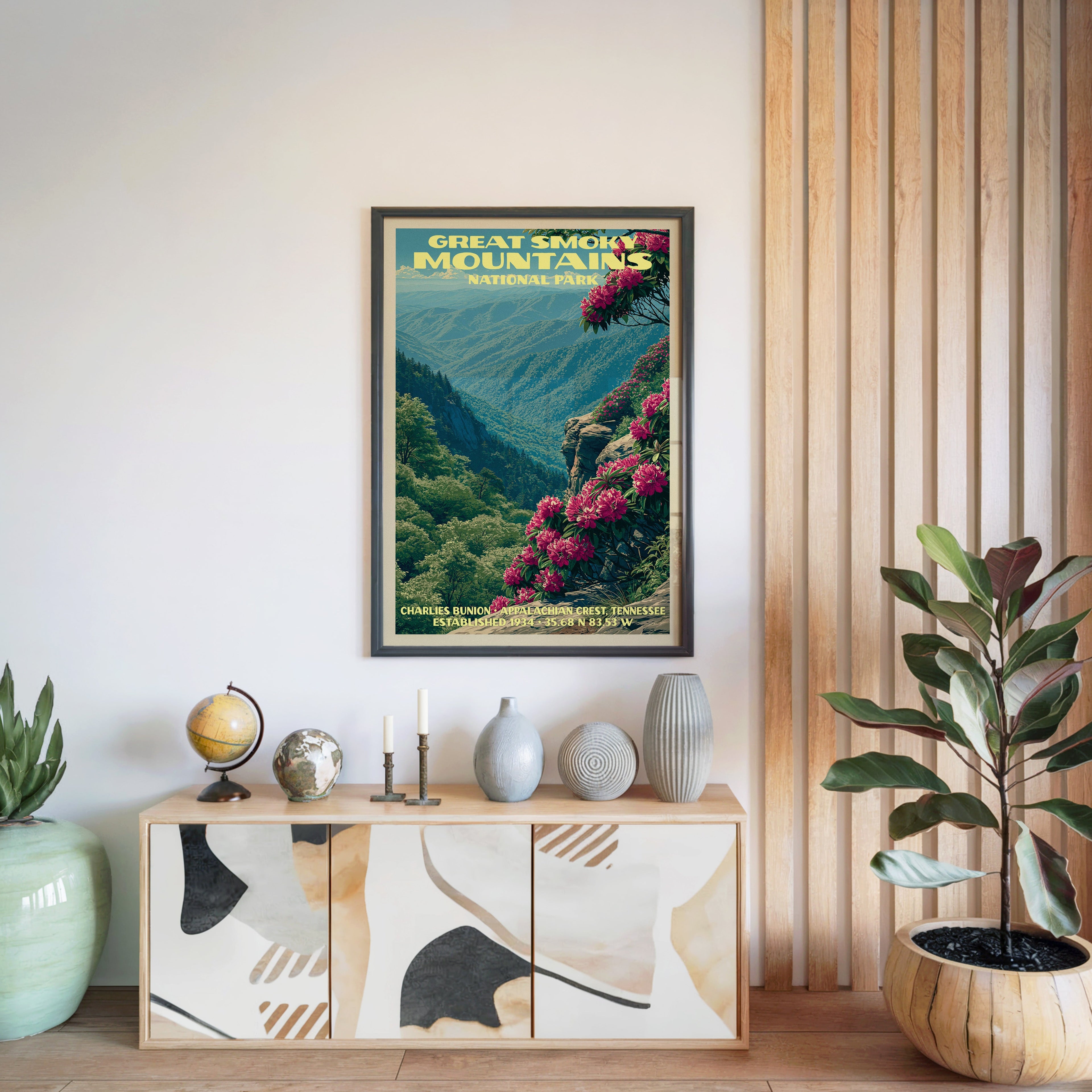 Great Smoky Mountains National Park poster in a black frame above a light wood sideboard with a globe and a candlestick