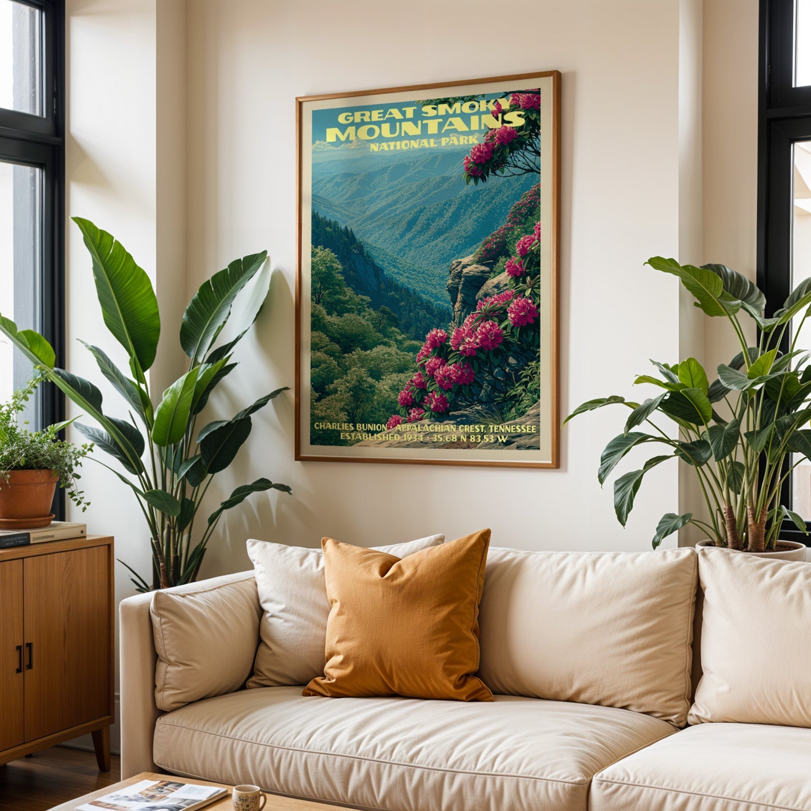 Great Smoky Mountains vintage travel print in oak above a cream sofa with a rust cushion and tall tropical plants