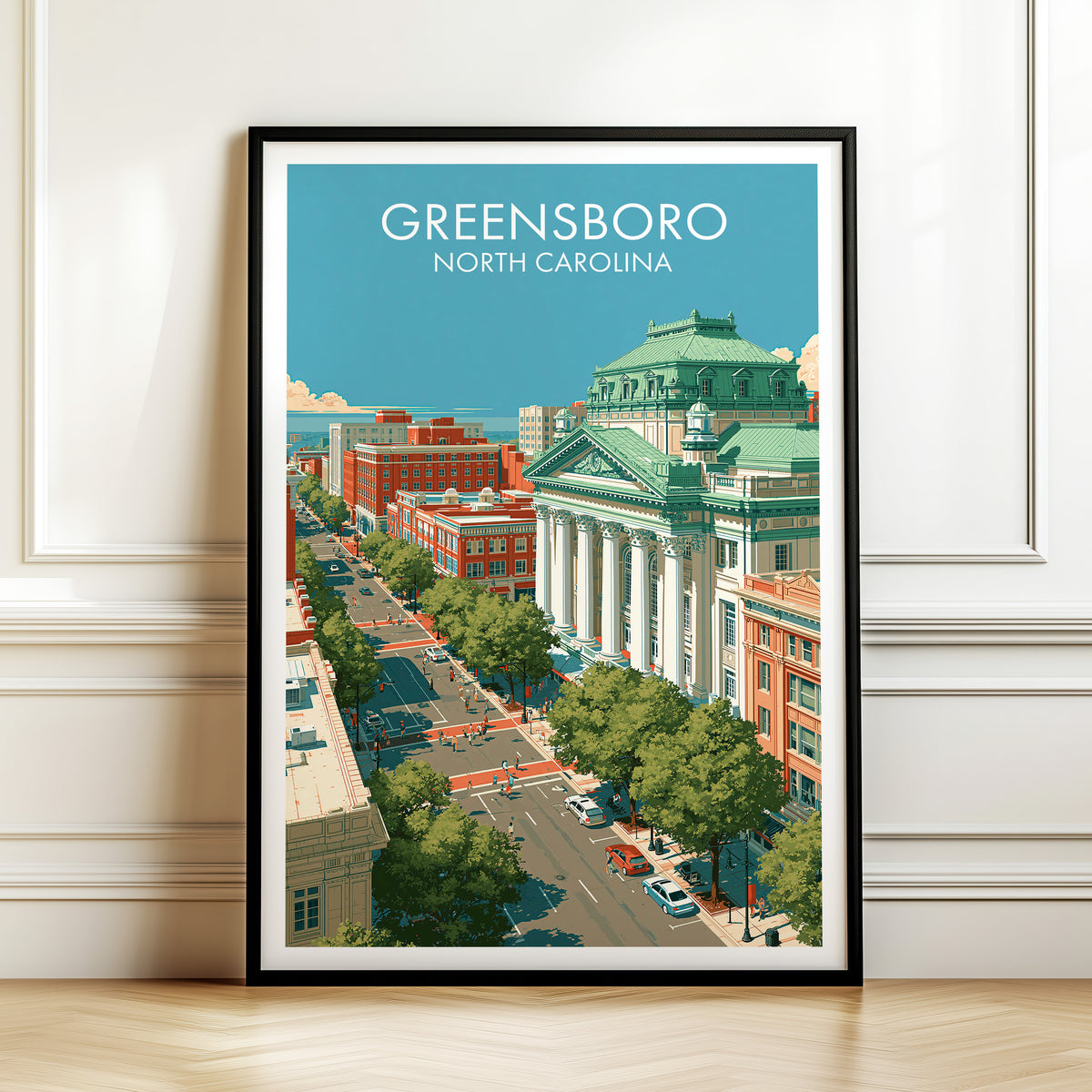 Greensboro North Carolina print in a black frame on a panelled wall above herringbone boards