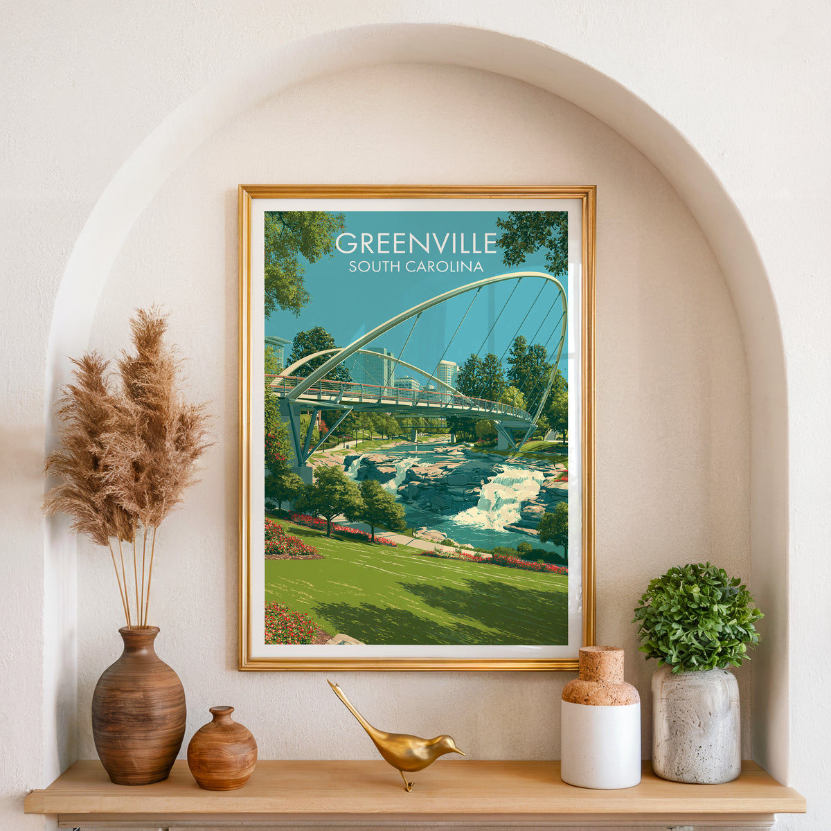 Greenville print in a gold frame set in an arched niche with pampas grass and a small plant