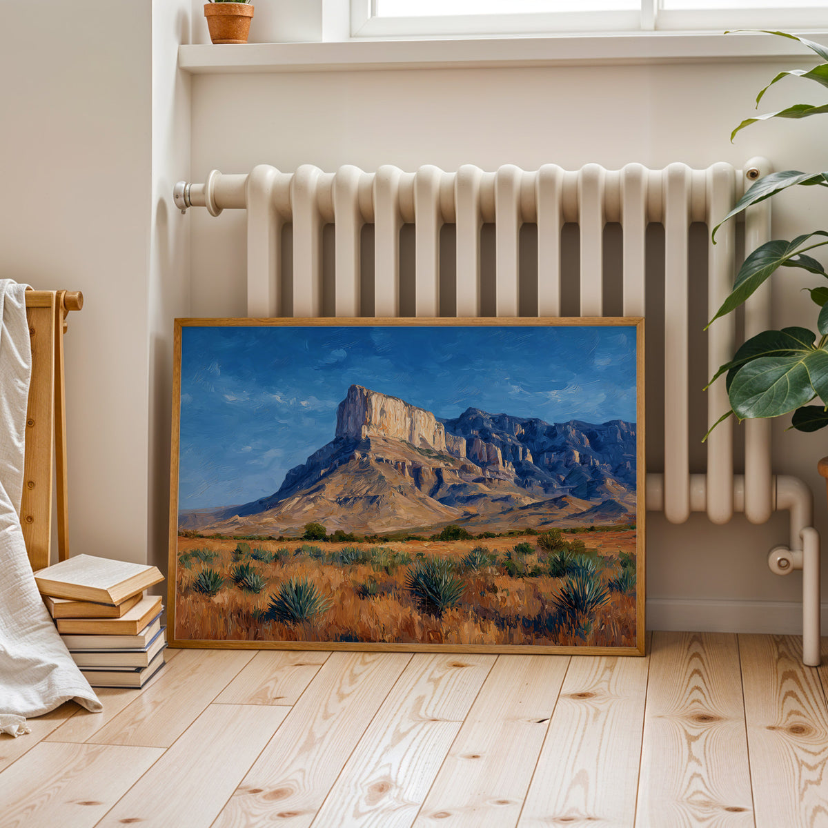 Guadalupe Mountains canvas in a walnut frame above a cognac leather sofa in lamplight