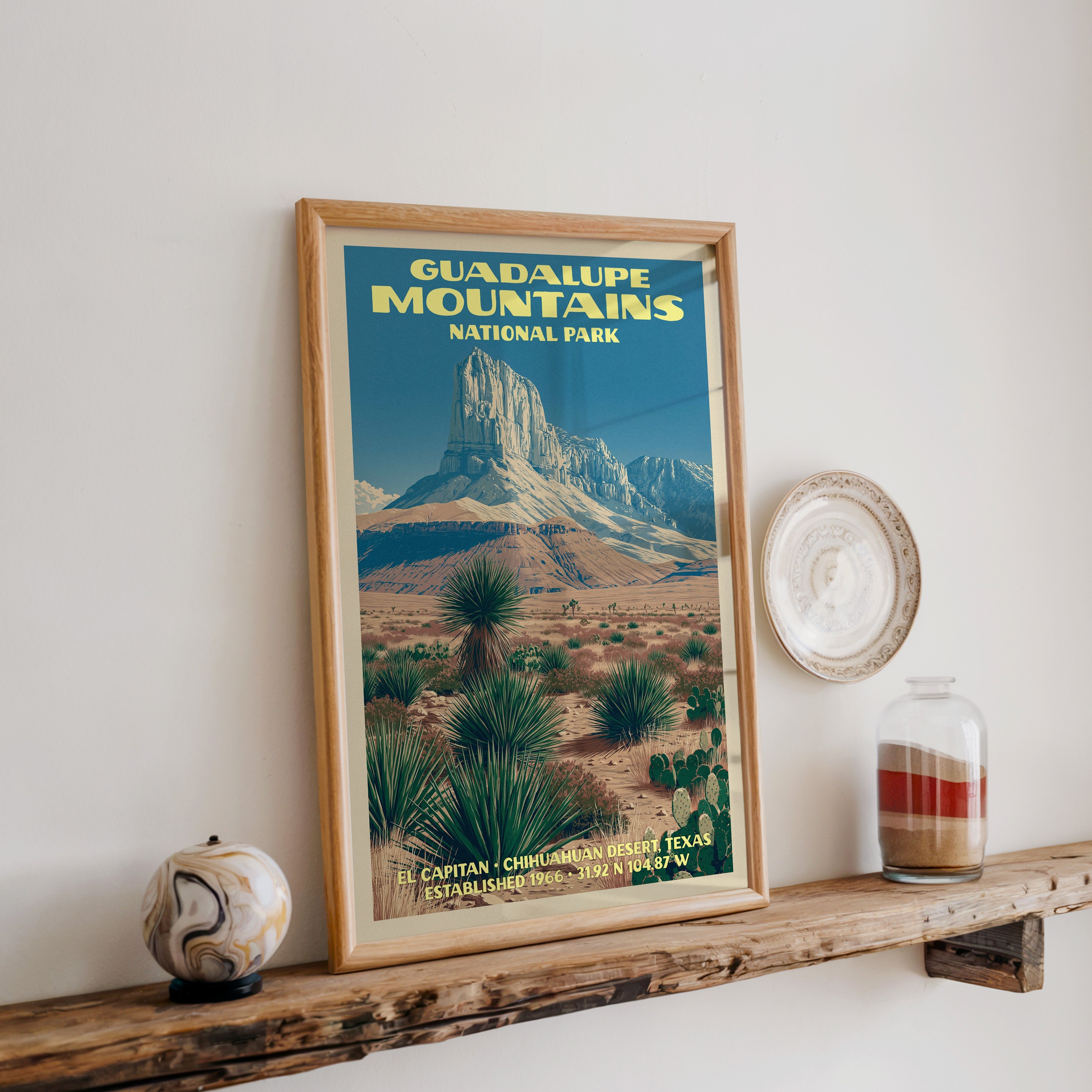 Guadalupe Mountains print in oak, leaning on a reclaimed wood ledge with a marbled stone sphere and a sand jar