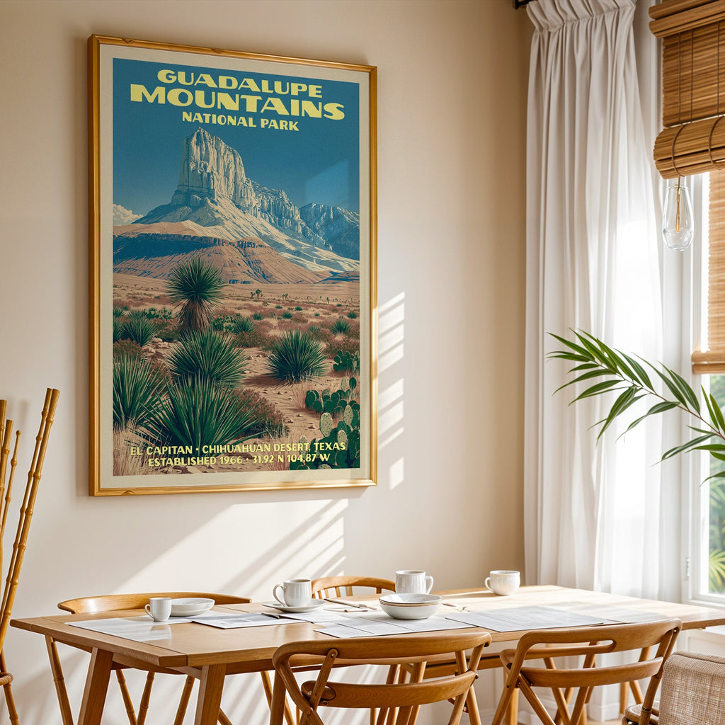 Guadalupe Mountains National Park print in a gold frame above a light oak dining table by a curtained window