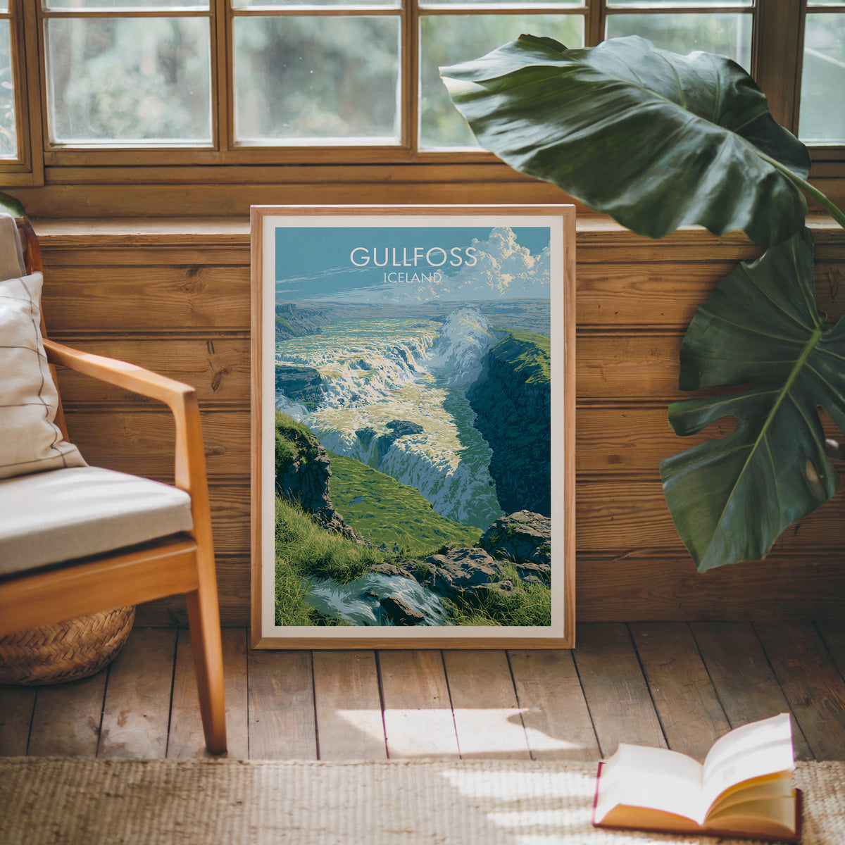 Gullfoss travel poster, oak frame leaning on a wood-panelled sunroom wall by a mid-century armchair