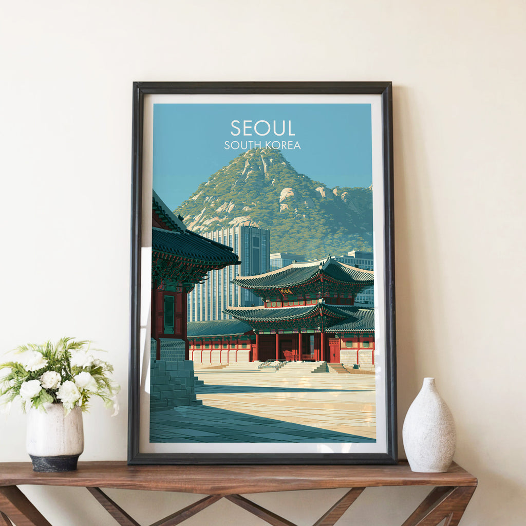Gyeongbokgung Palace Seoul travel poster in a black frame on a wooden console table with white flowers