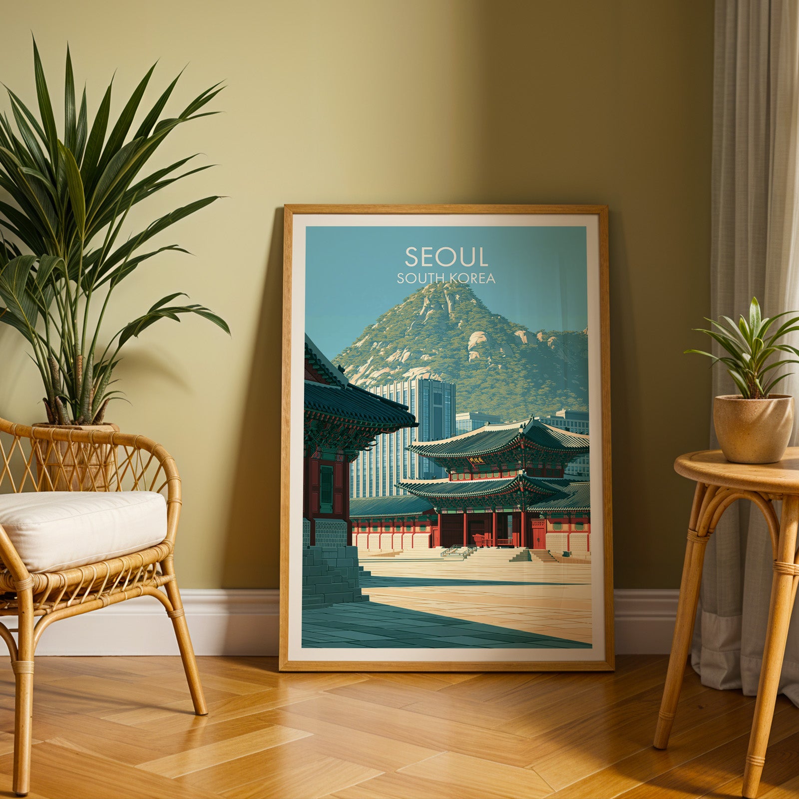 Large Gyeongbokgung Palace Seoul travel print in an oak frame leaning on a herringbone floor next to a rattan chair