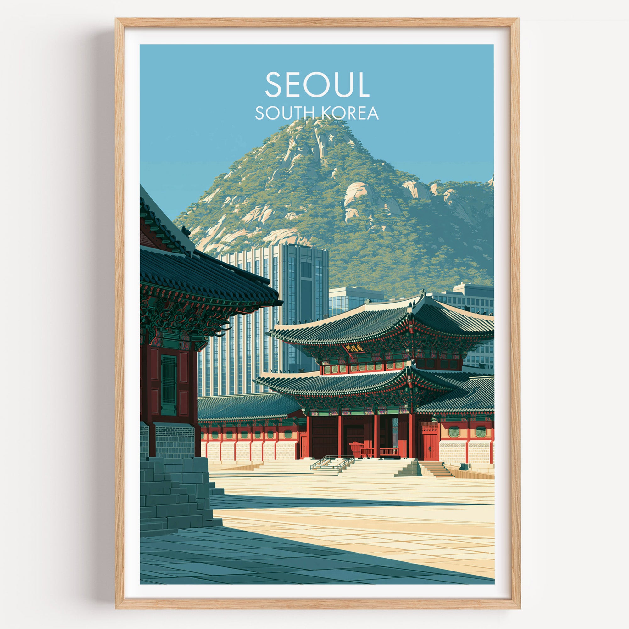 Gyeongbokgung Palace Seoul travel poster in a natural wood frame, shown against a clean white wall