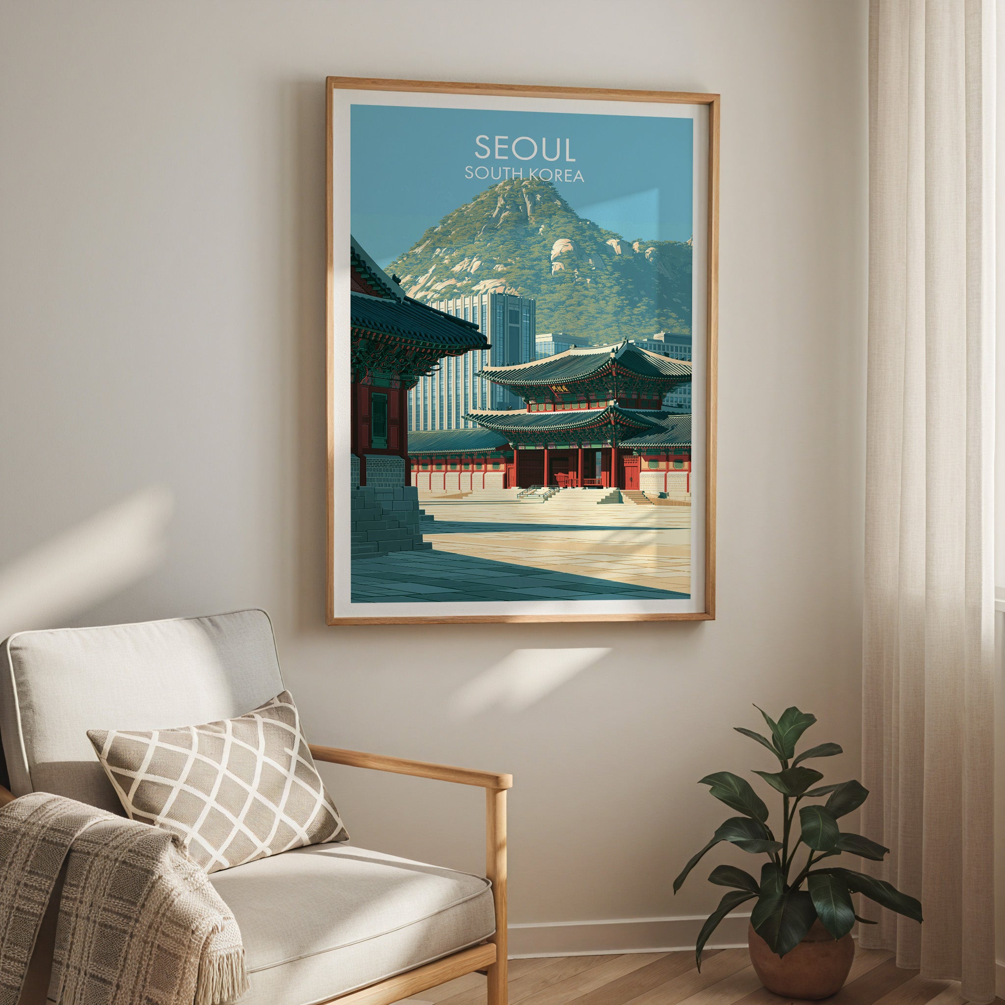 Gyeongbokgung Palace Seoul travel print in a light oak frame on a living room wall beside a linen armchair