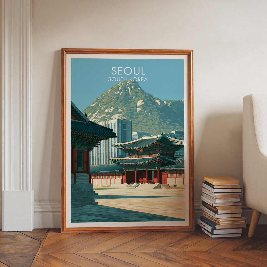 Gyeongbokgung Palace Seoul art print in a walnut frame leaning in a hallway beside stacked books